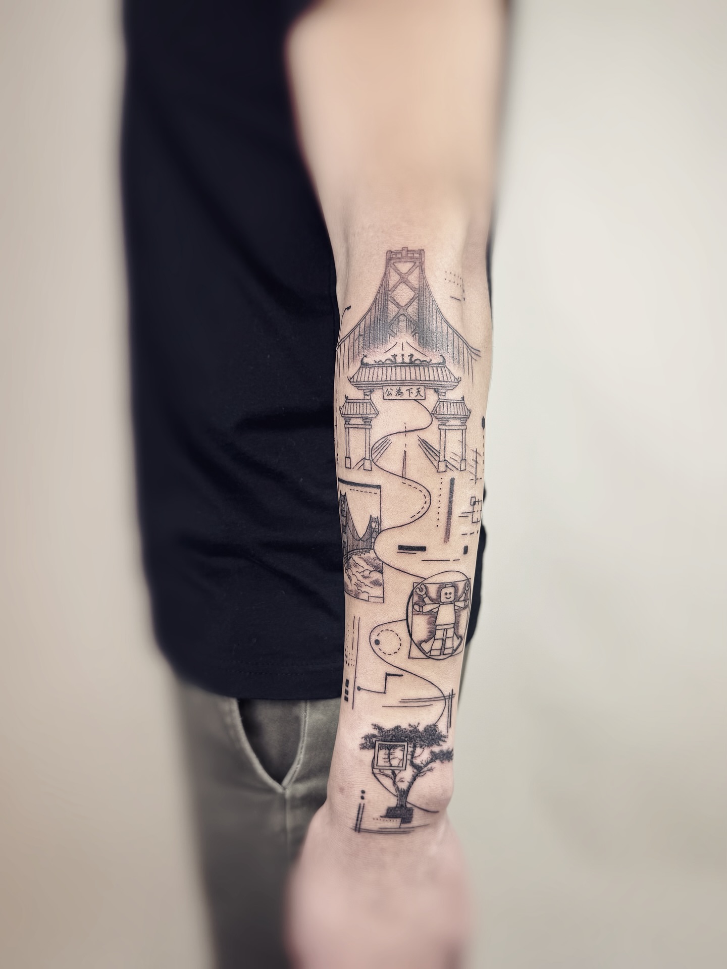 Bridge and gate black and grey tattoo on the forearm by Jadyn Pang