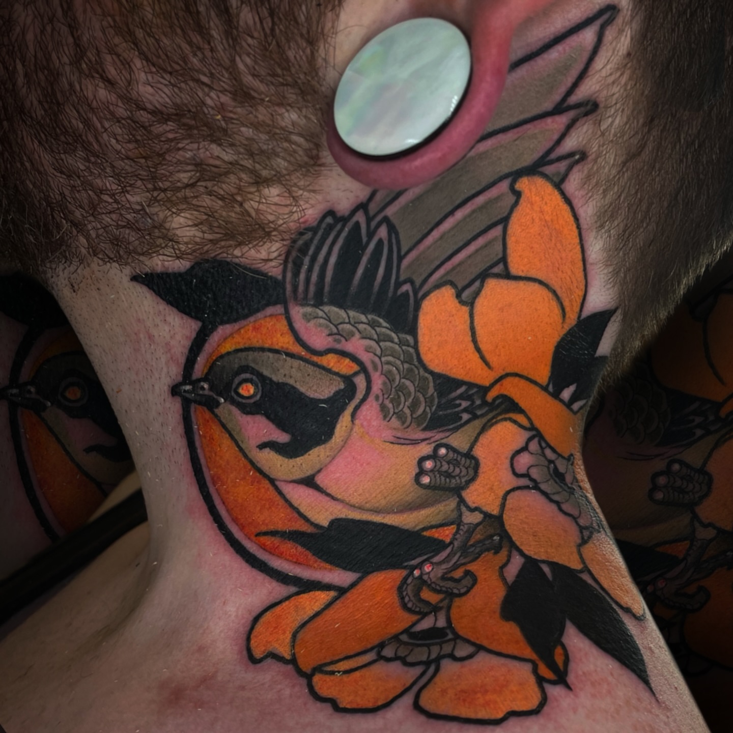 Bird and flower American traditional tattoo on the neck by Nathan Mickle