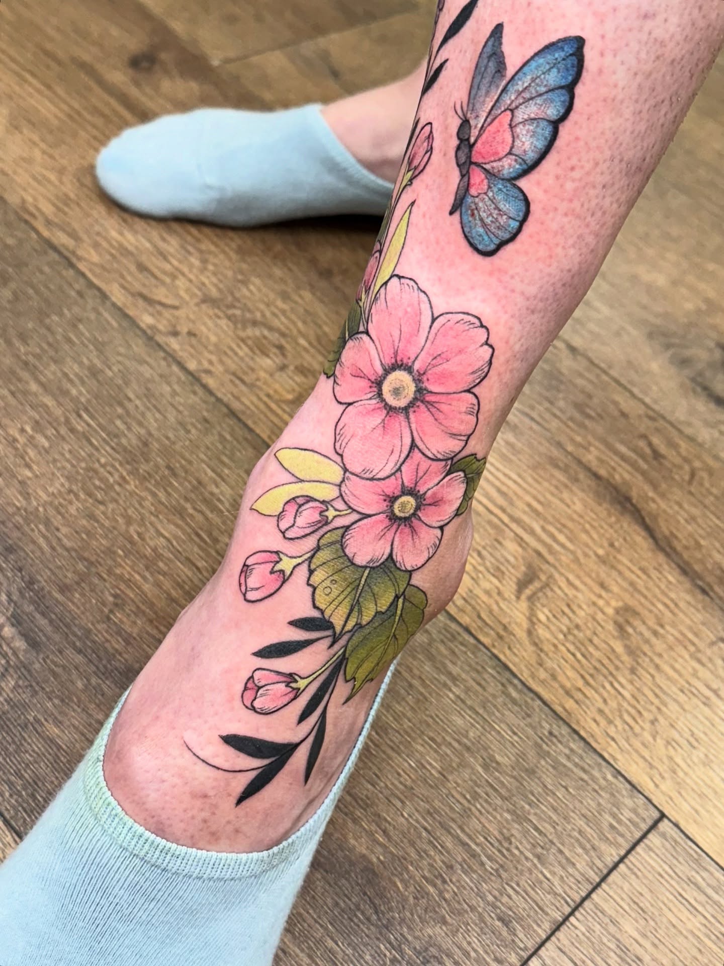 Flowers and butterfly watercolor tattoo on the forearm by Maia Papaya Tattoos 🐝 Olympia Tattoo Artist