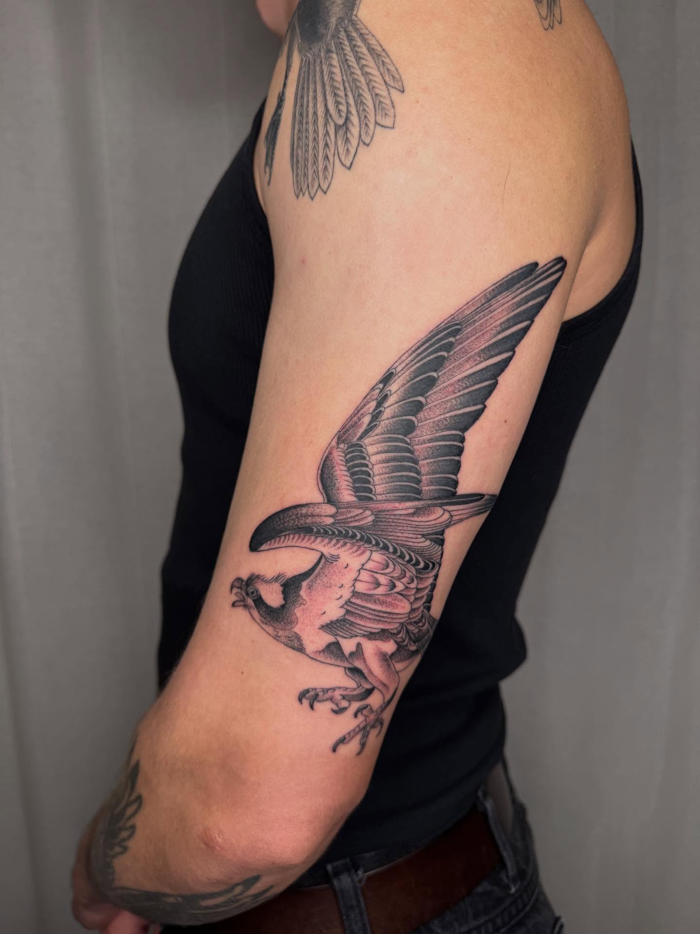 Bird black and grey tattoo on the forearm by Finley Jordan