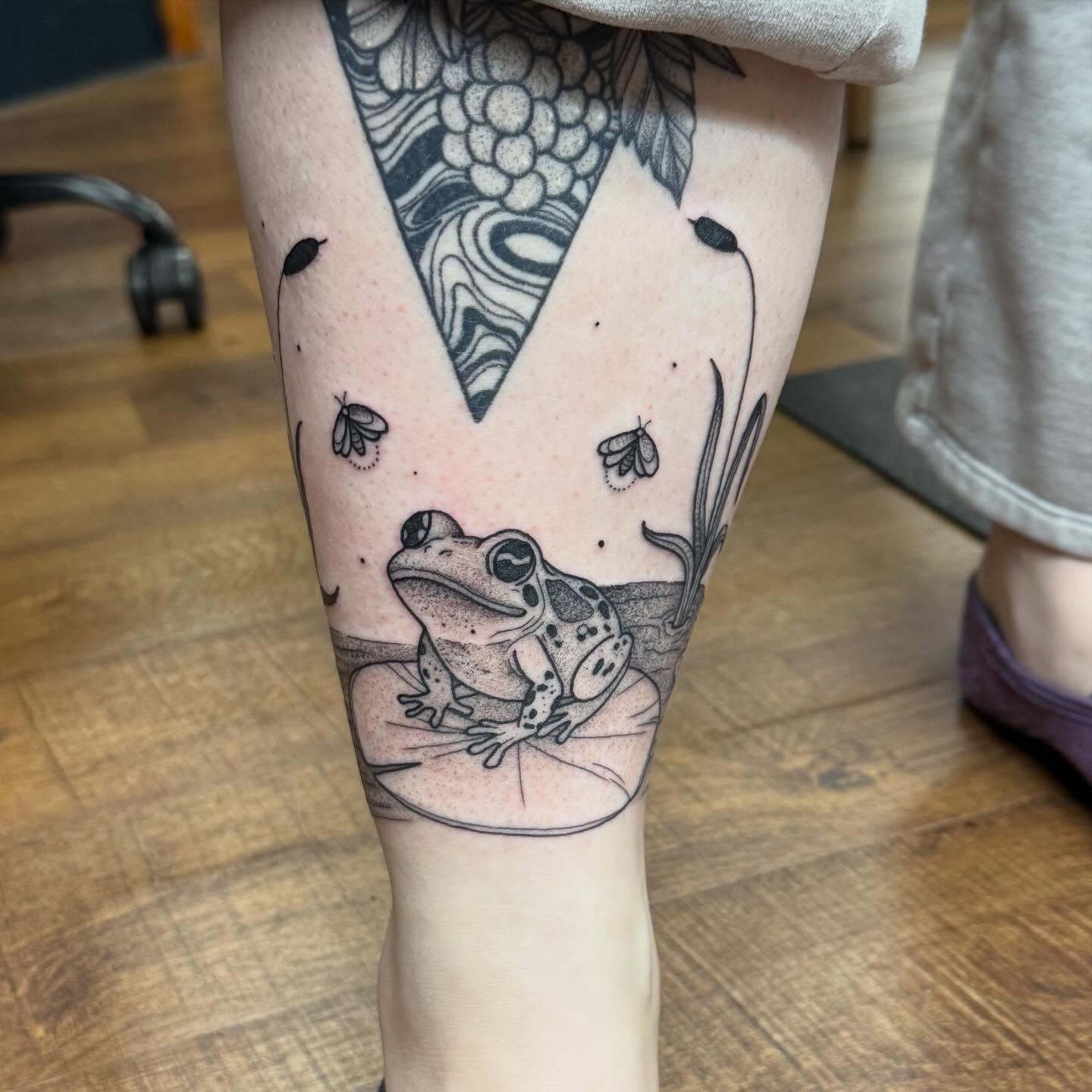 Frog black and grey tattoo on the calf by Erica Rose π€