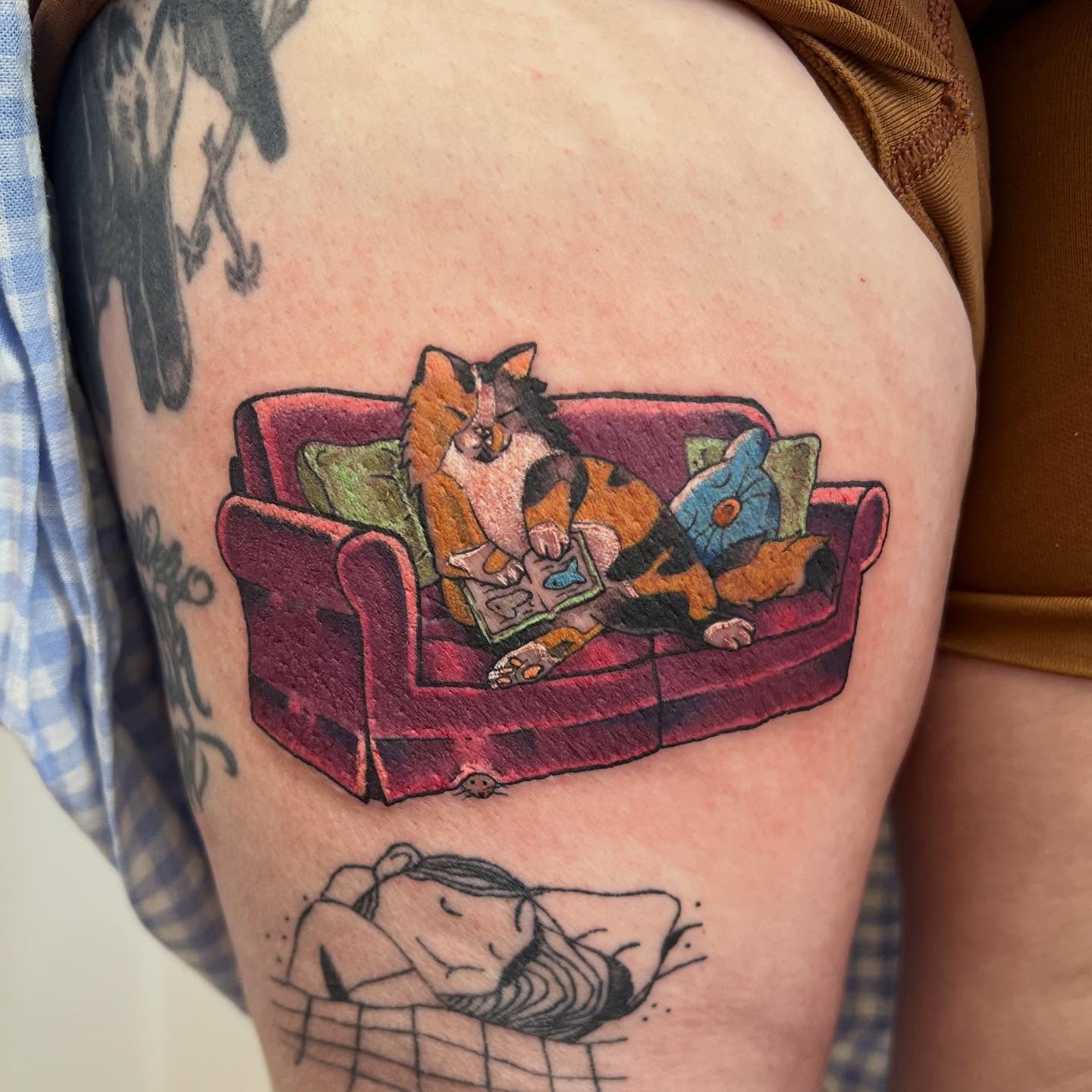 Calico cat reading realism tattoo on the thigh by 🍄‍🟫🍄Moth🍄🍄‍🟫