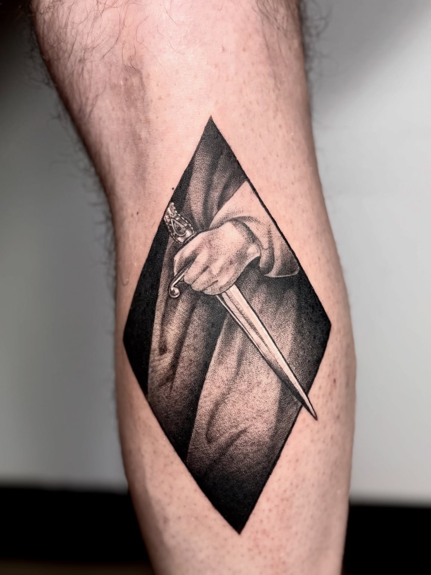 Knife and hooded figure dotwork tattoo on the forearm by Abrianna