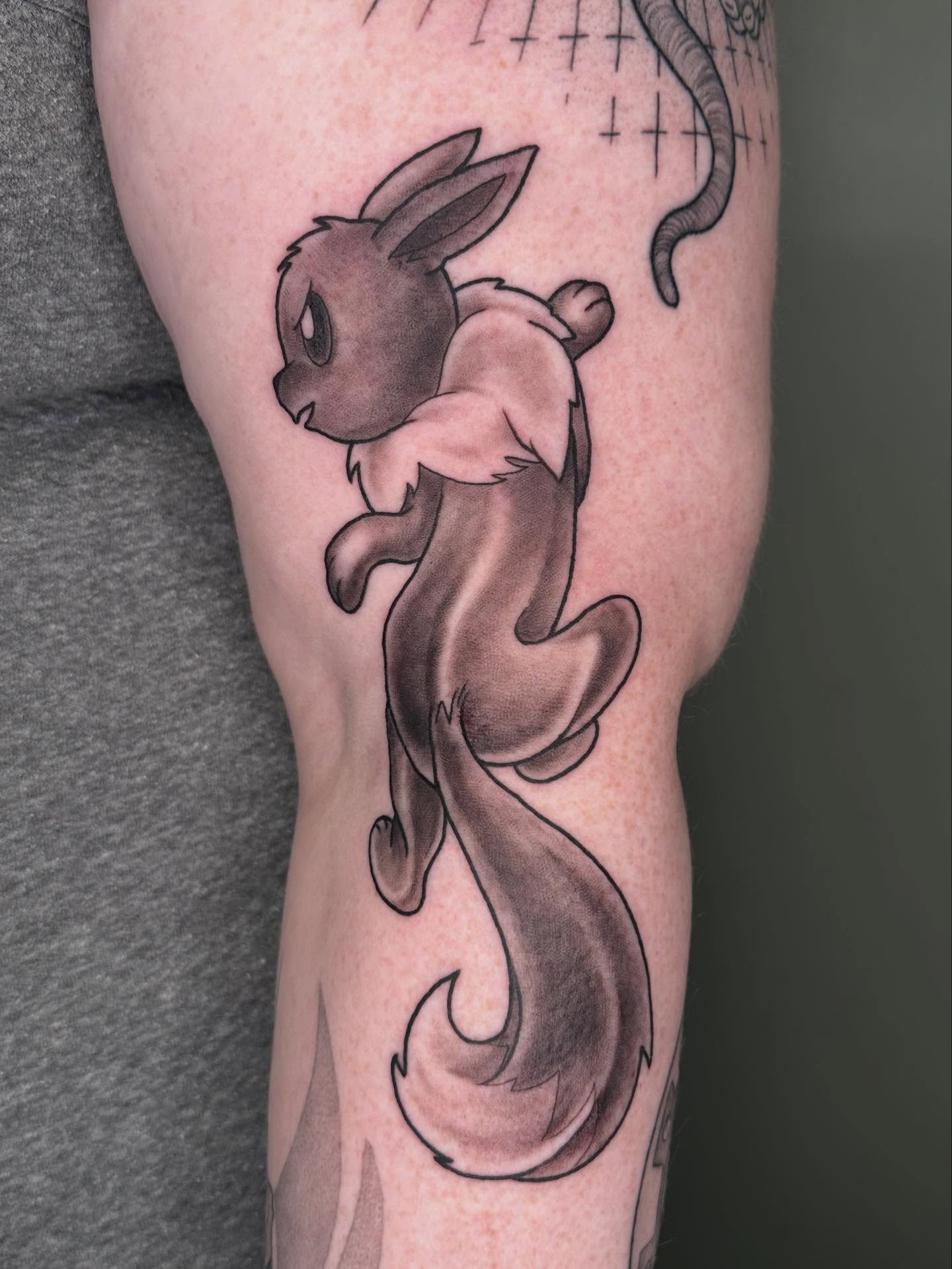 Eevee black and grey tattoo on the forearm by Hi