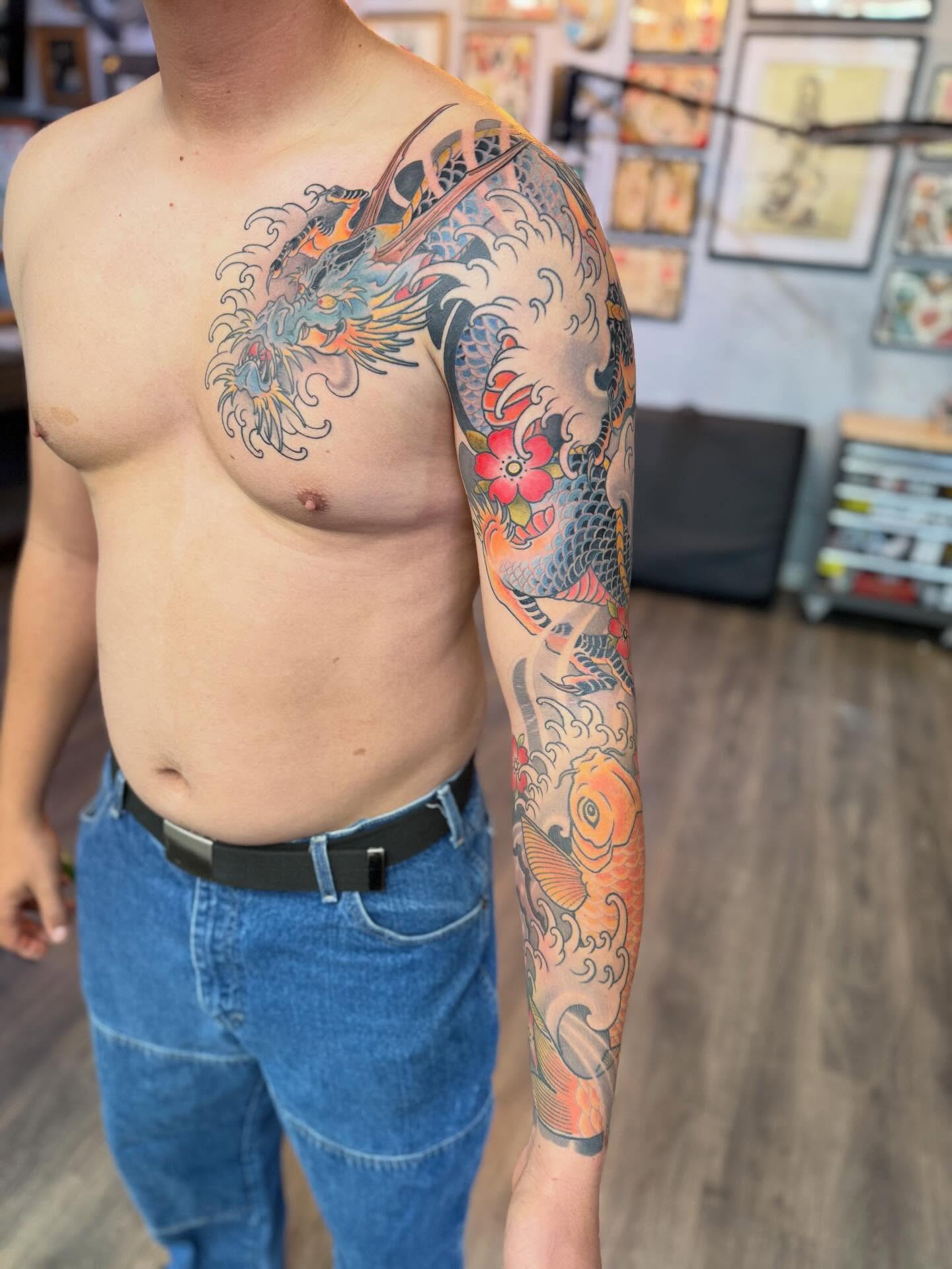 Dragon and koi japanese irezumi tattoo on the upper arm by Chase Martines