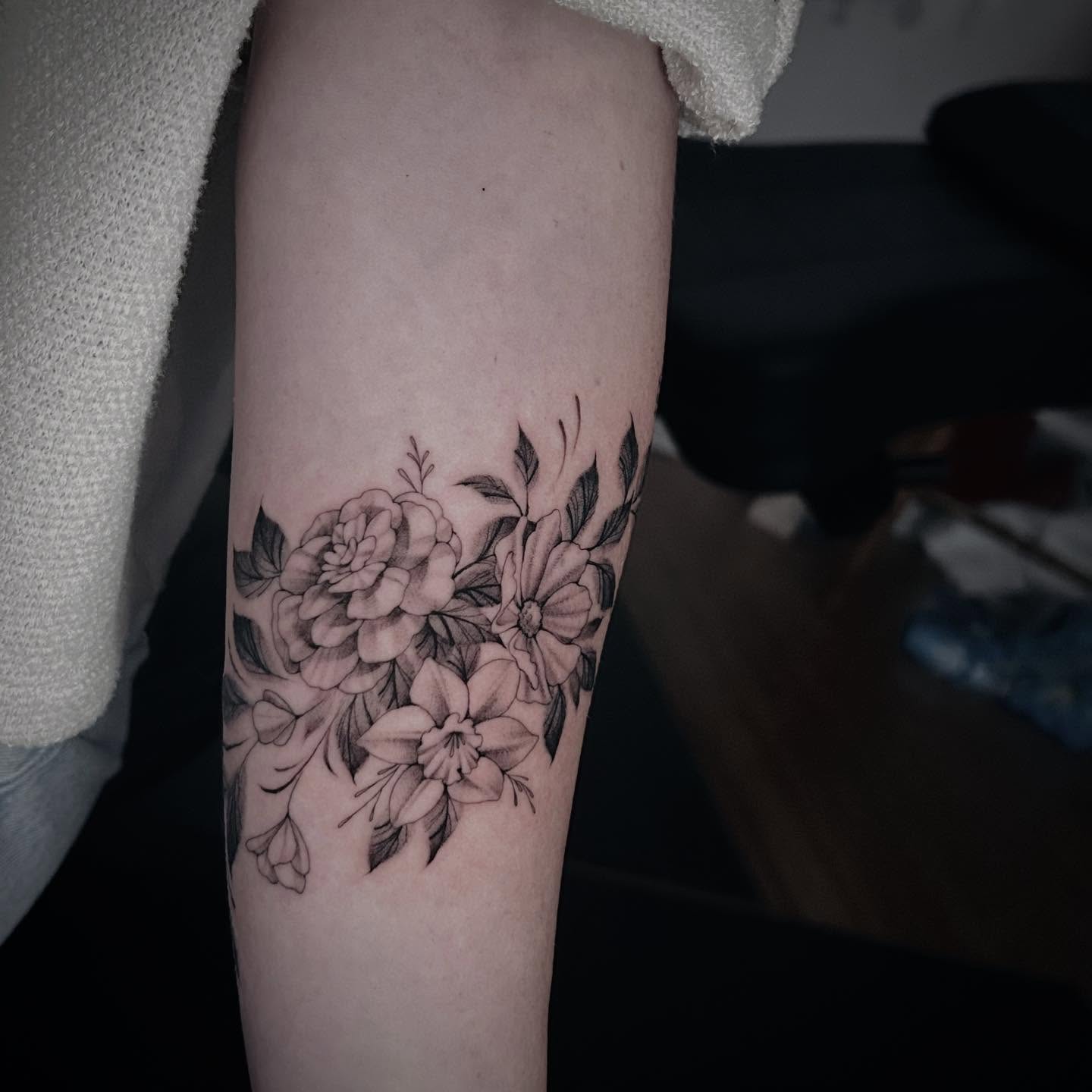 Floral bouquet black and grey tattoo on the forearm by Jonny Tattoo PHX AZ
