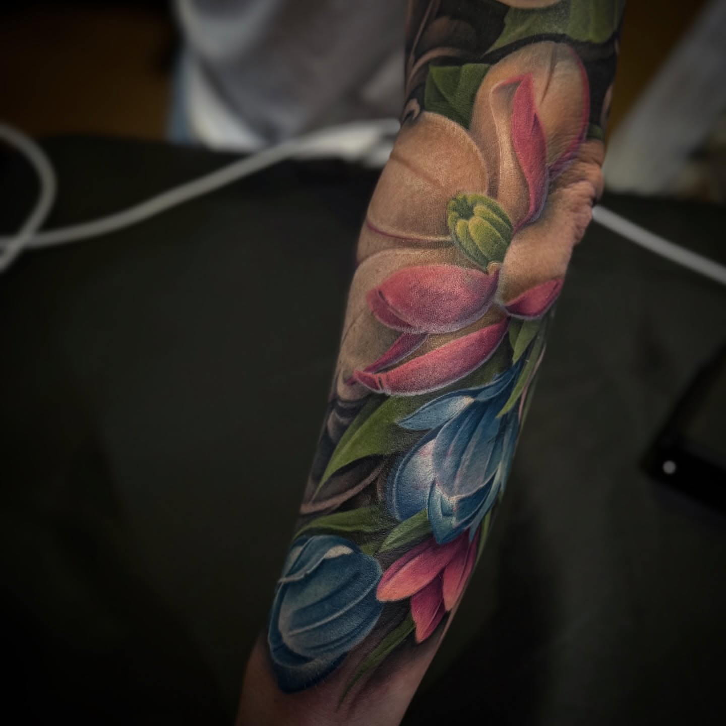 Floral bouquet realism tattoo on the forearm by James Hall