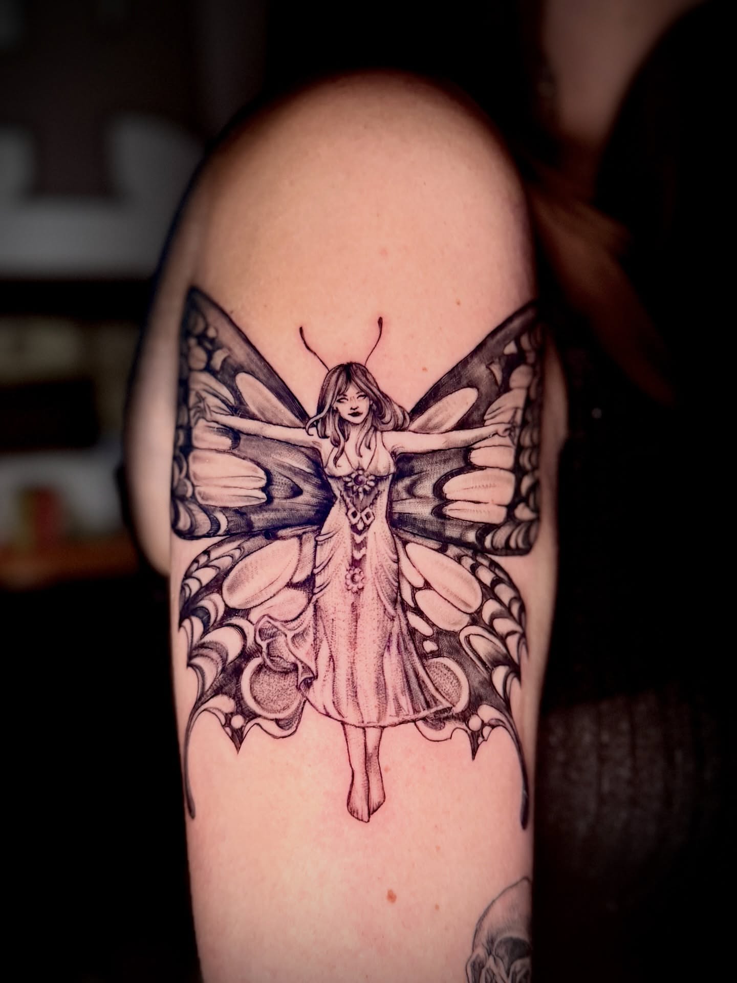 Butterfly fairy realism tattoo on the upper arm by Giovanna Kline