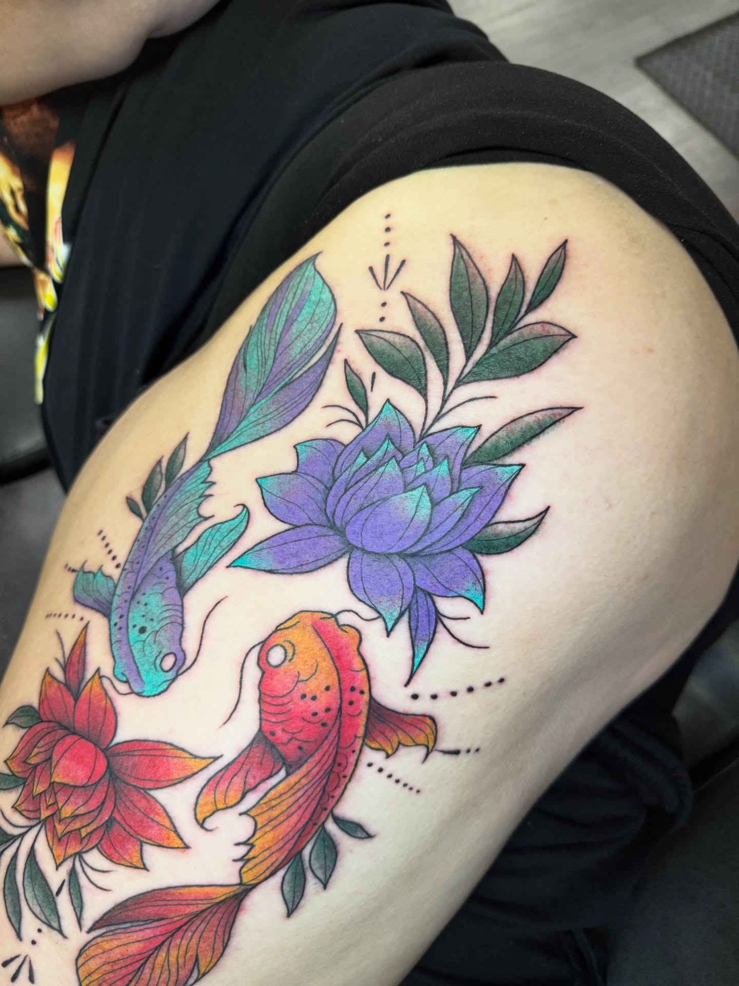 Koi fish and lotus flowers new school tattoo on the thigh by @ryanpereztattoo