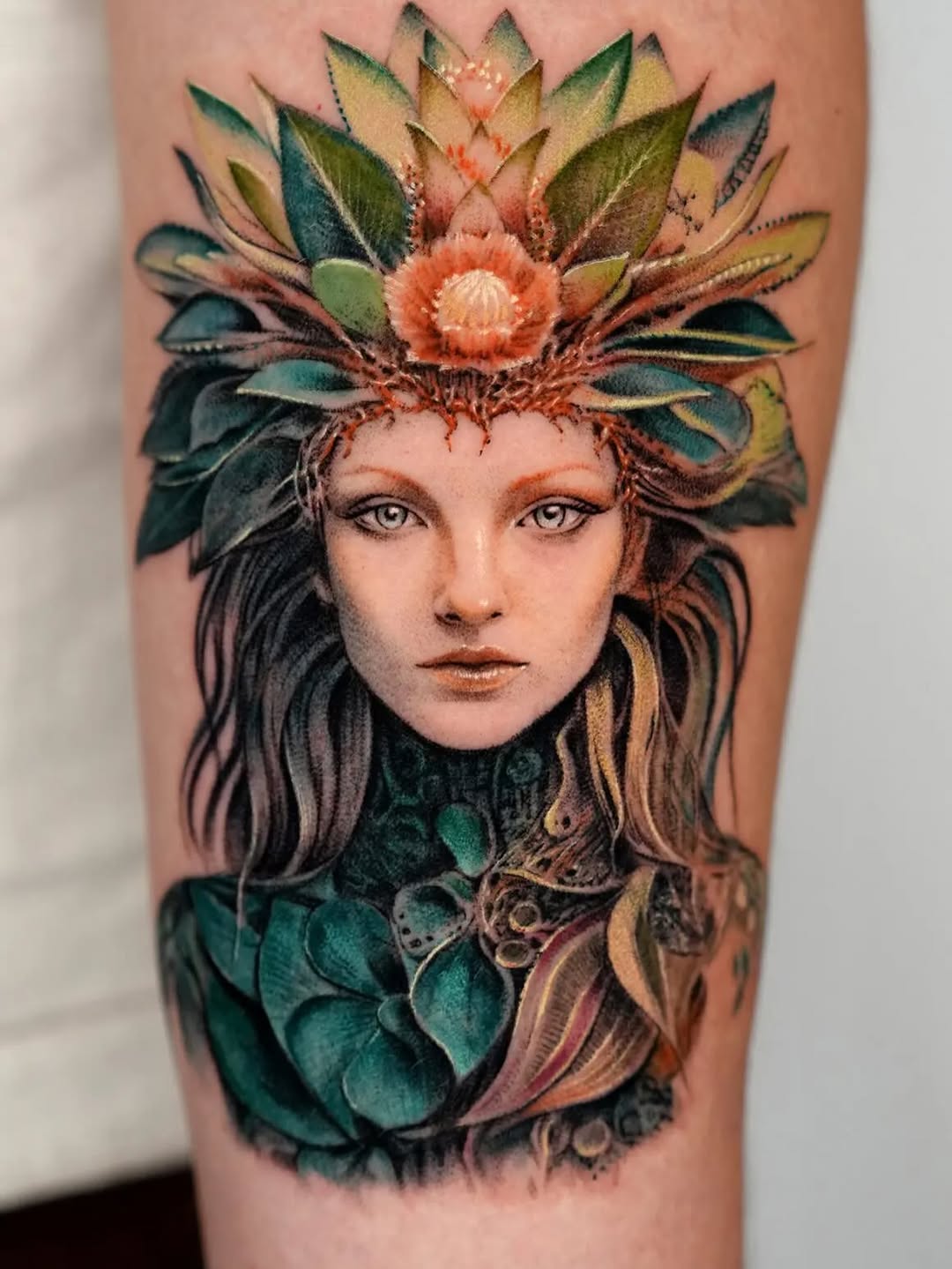 Woman with floral headdress realism tattoo on the forearm by Jun