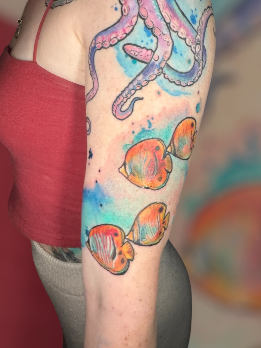 Octopus and fish watercolor tattoo on the forearm by Paula.p.tattoos