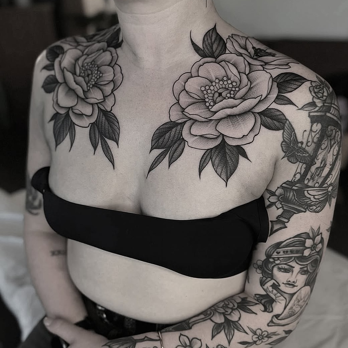 Floral black and grey tattoo on the chest by Luna Lucero