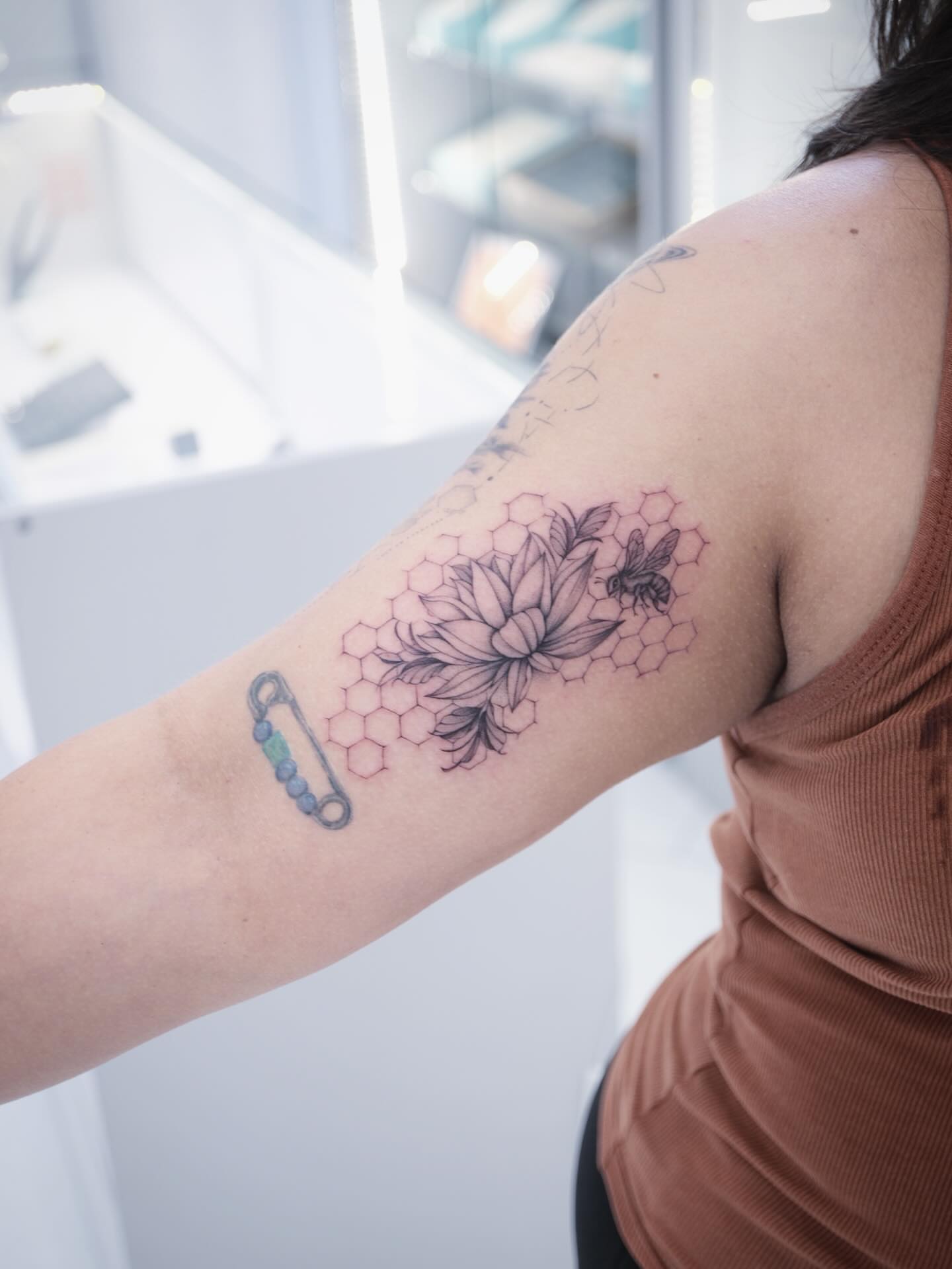 Flower and honeycomb geometric tattoo on the forearm by Raytattooist