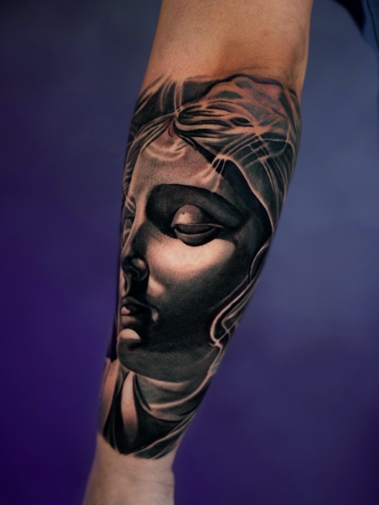 Abstract face realism tattoo on the forearm by Bailey Lemus