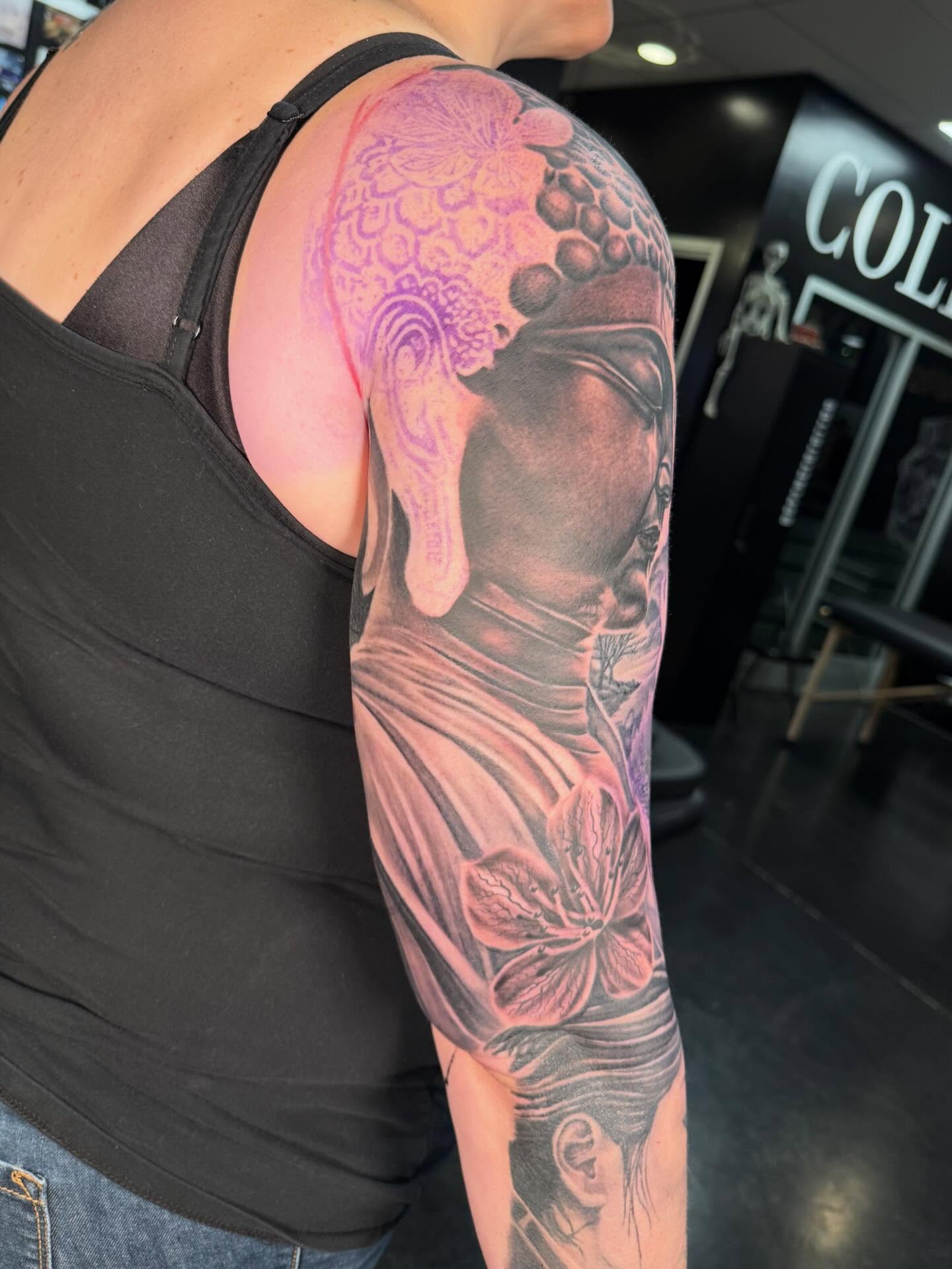Buddha realism tattoo on the upper arm by InkFloyd Roith