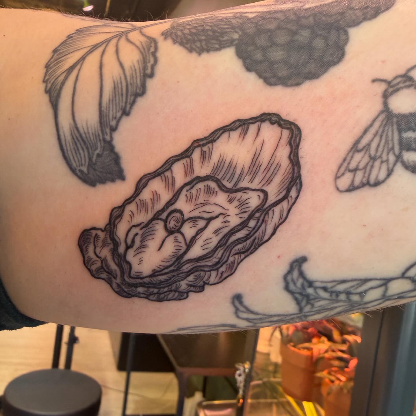Oyster black and grey tattoo on the forearm by Patrick Carroll
