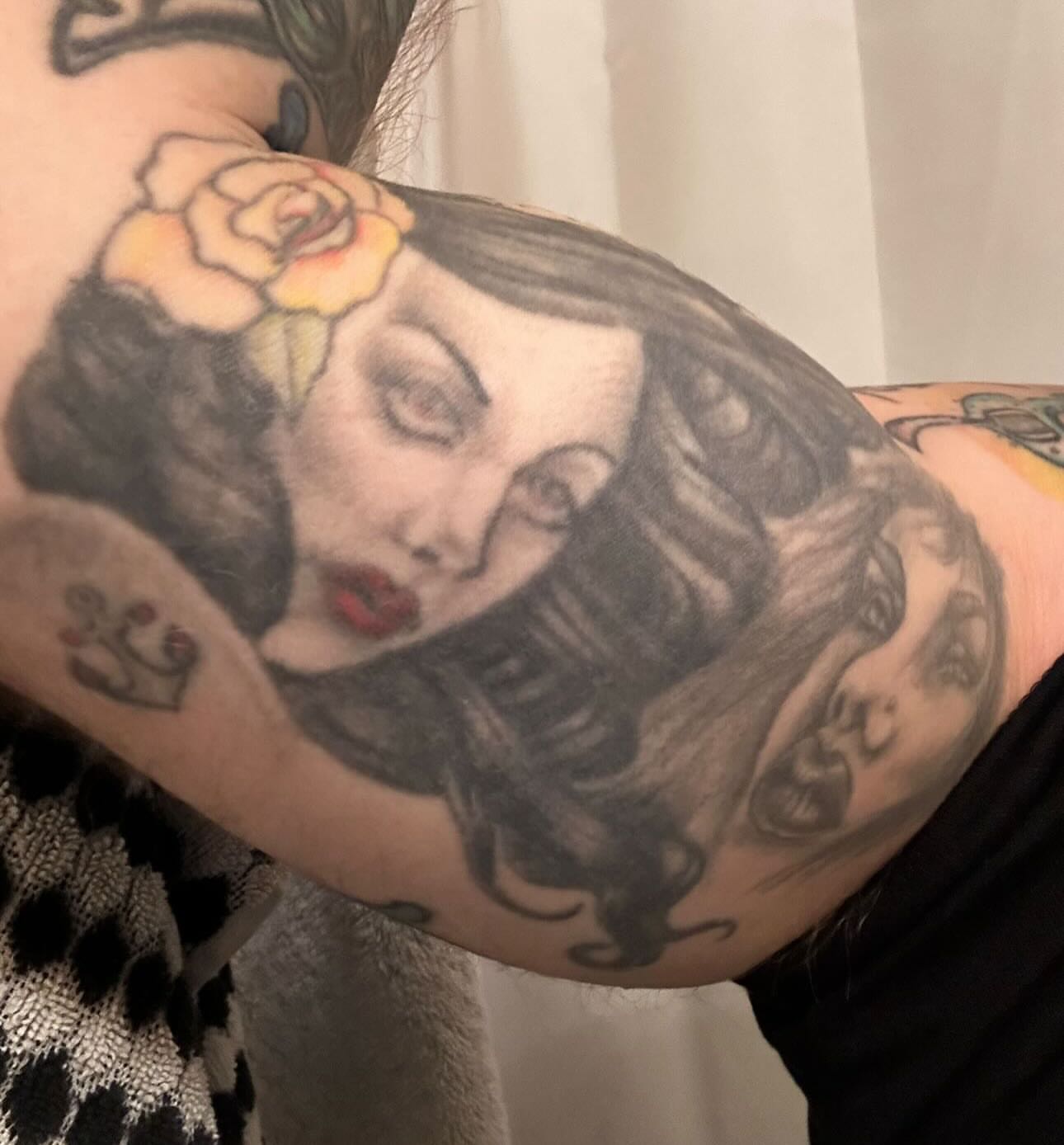 Woman with flower realism tattoo on the forearm by Holli Marie