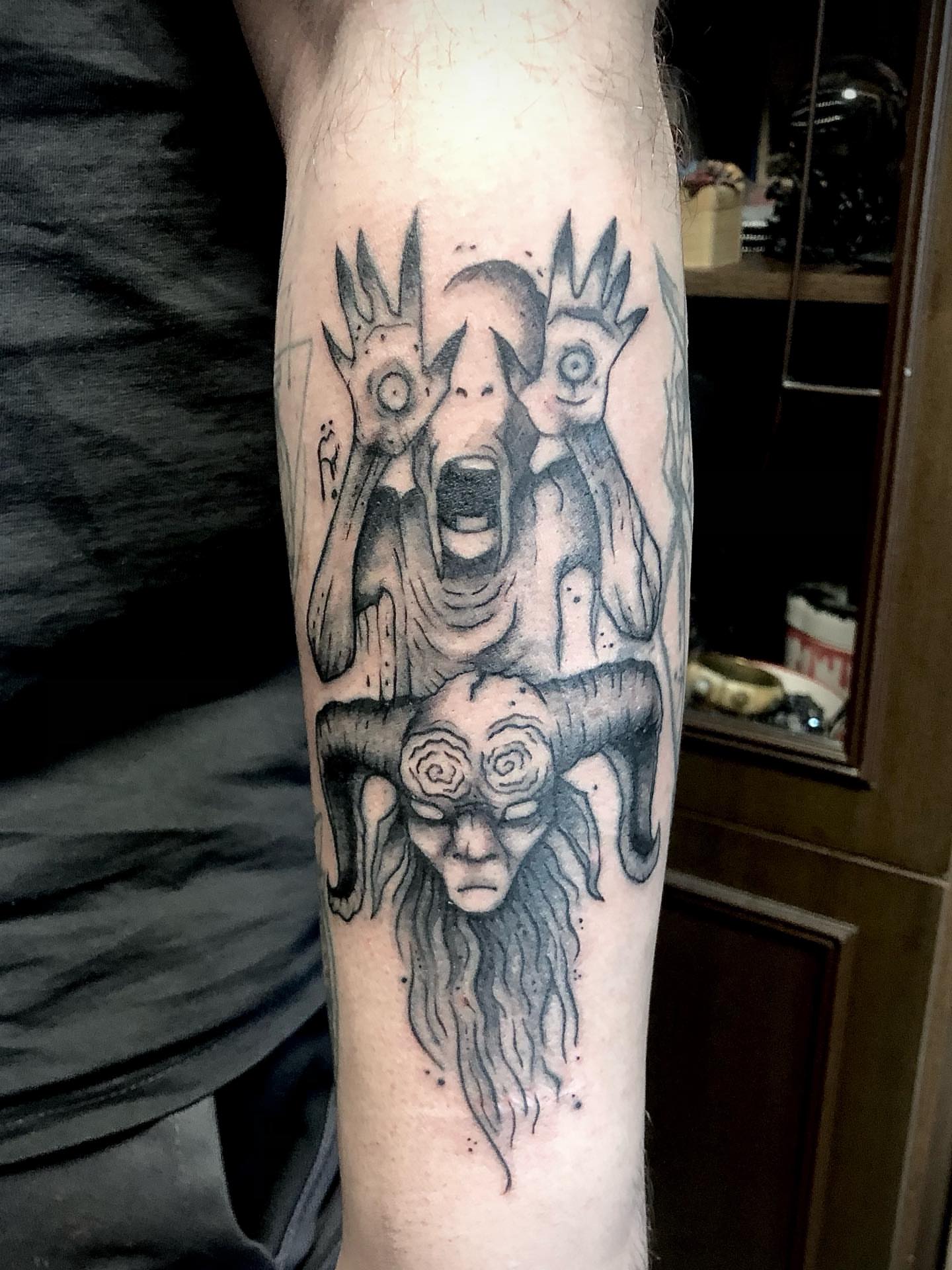 Demon dark realism tattoo on the forearm by Ink of Winchester