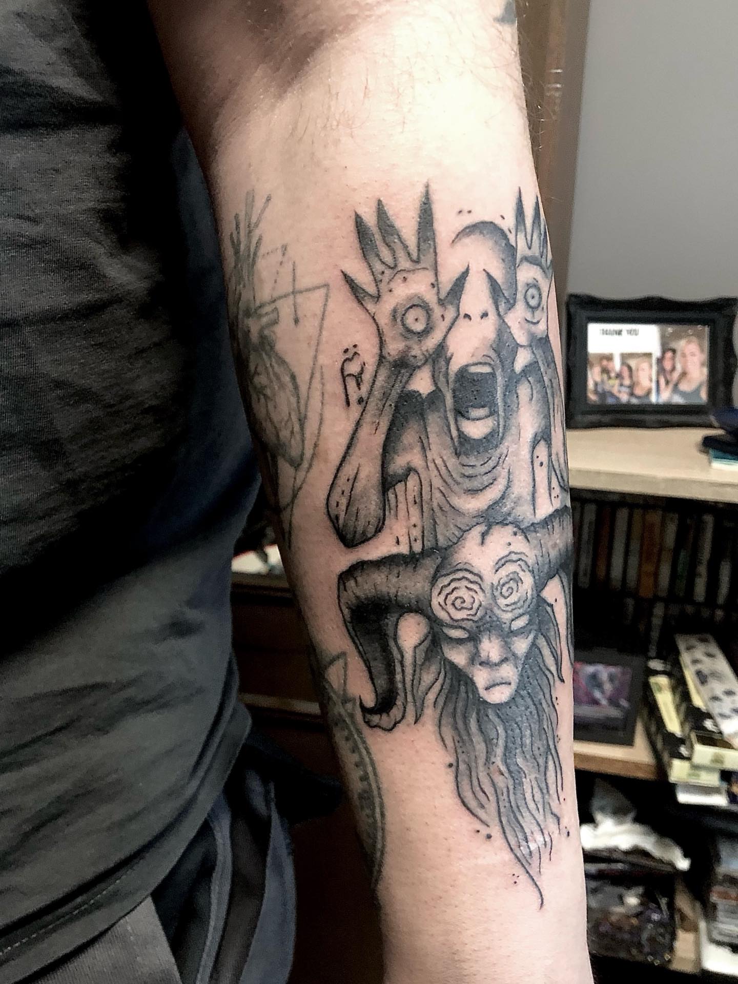 Demonic figures dark realism tattoo on the forearm by Ink of Winchester