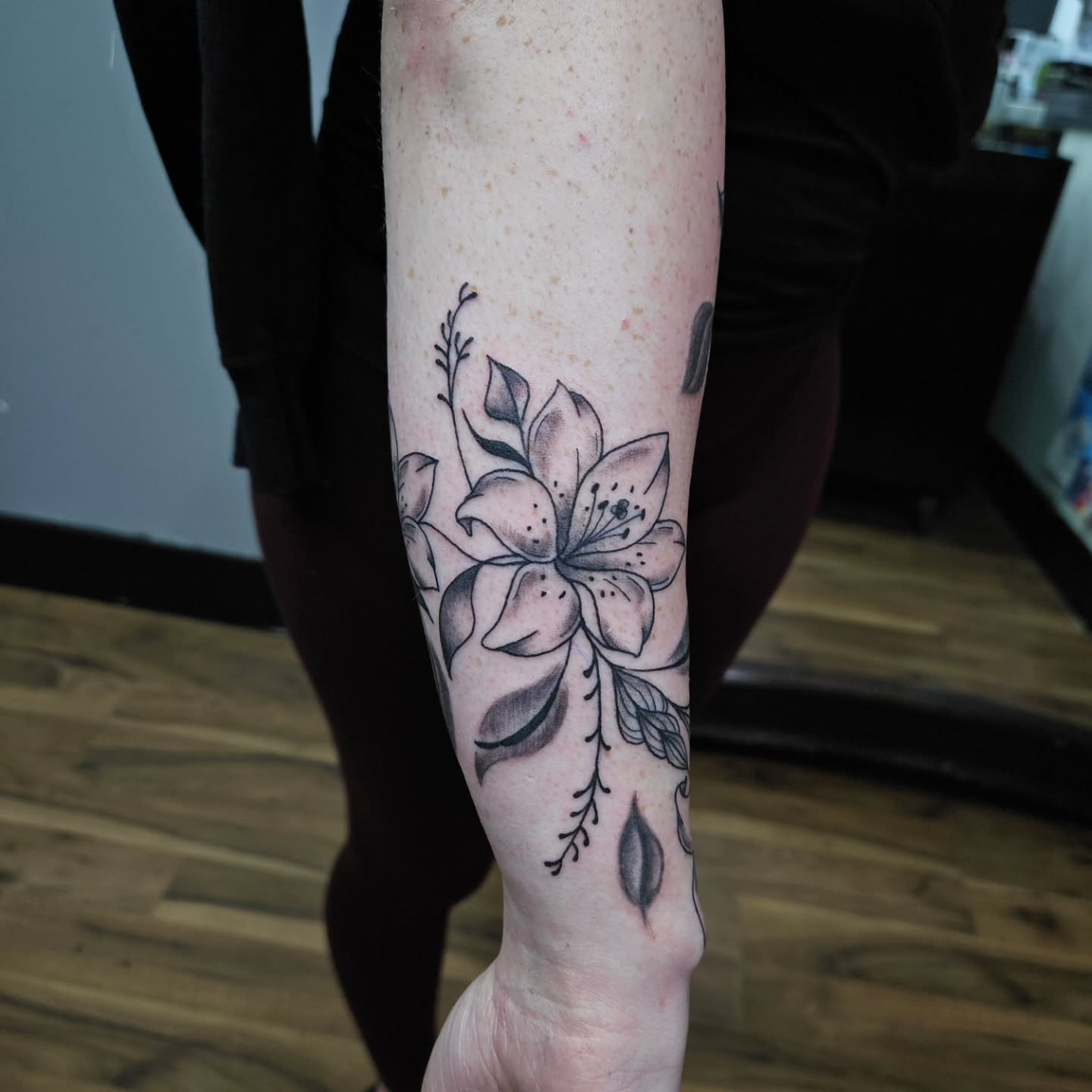 Flower black and grey tattoo on the forearm by Danny