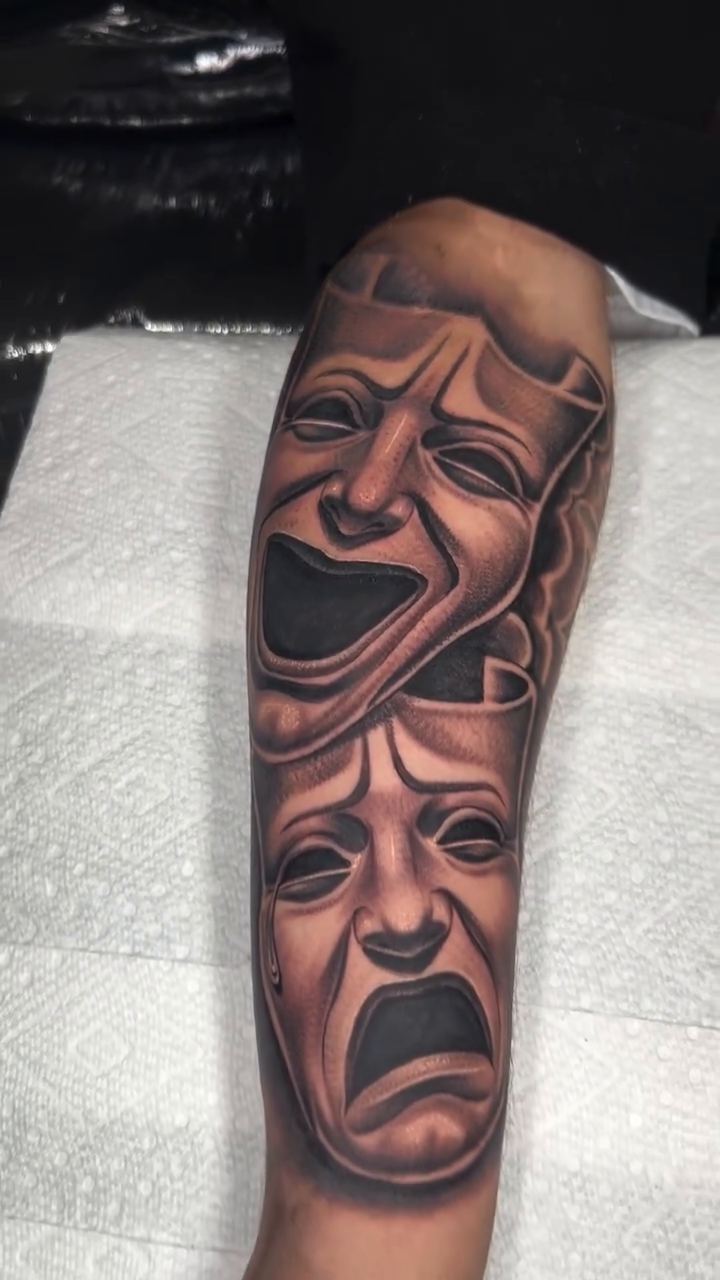 Comedy and tragedy masks realism tattoo by Isaac Barrientos