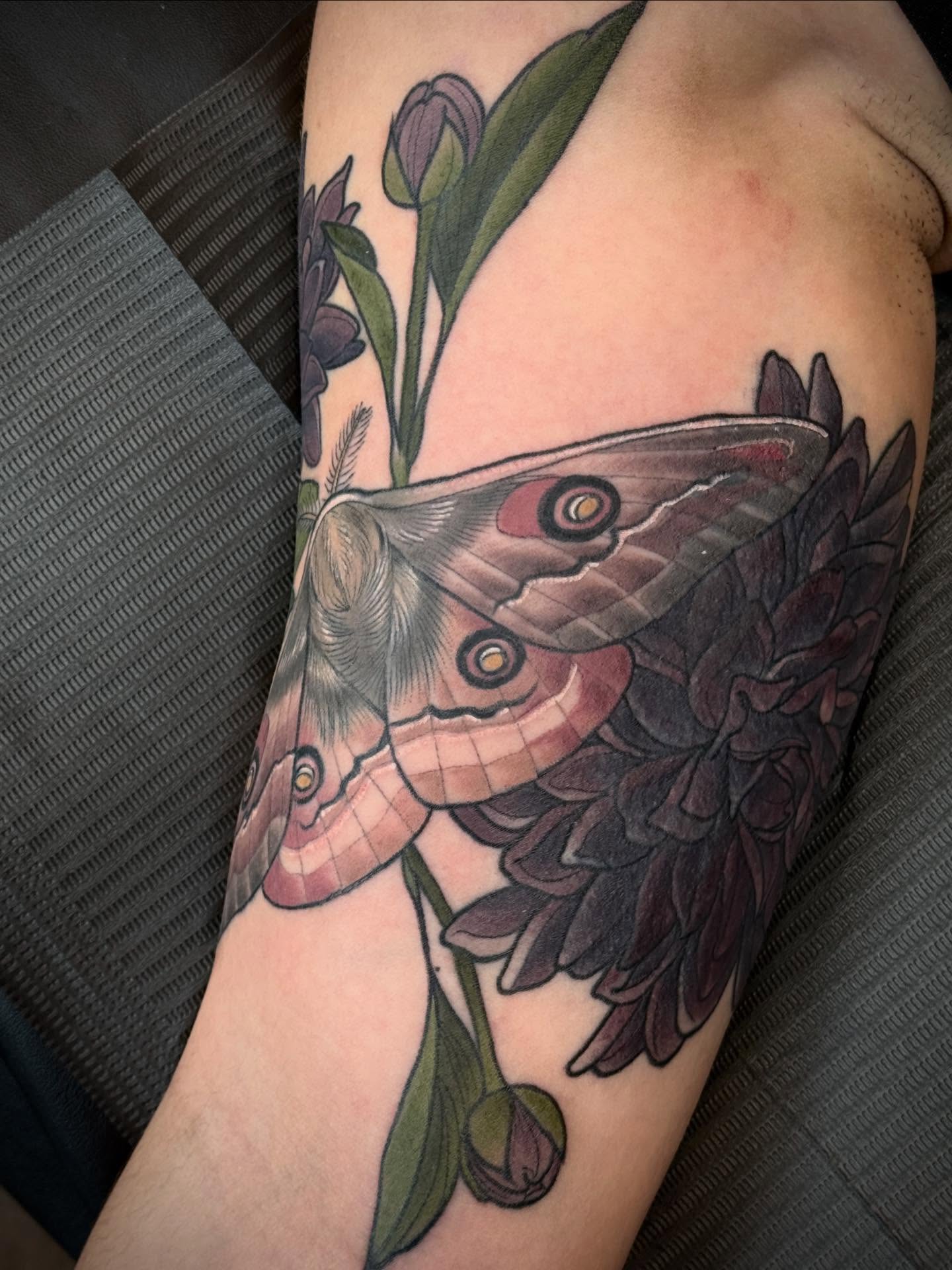 Peacock moth and tulips realism tattoo on the forearm by Rachael Shelly