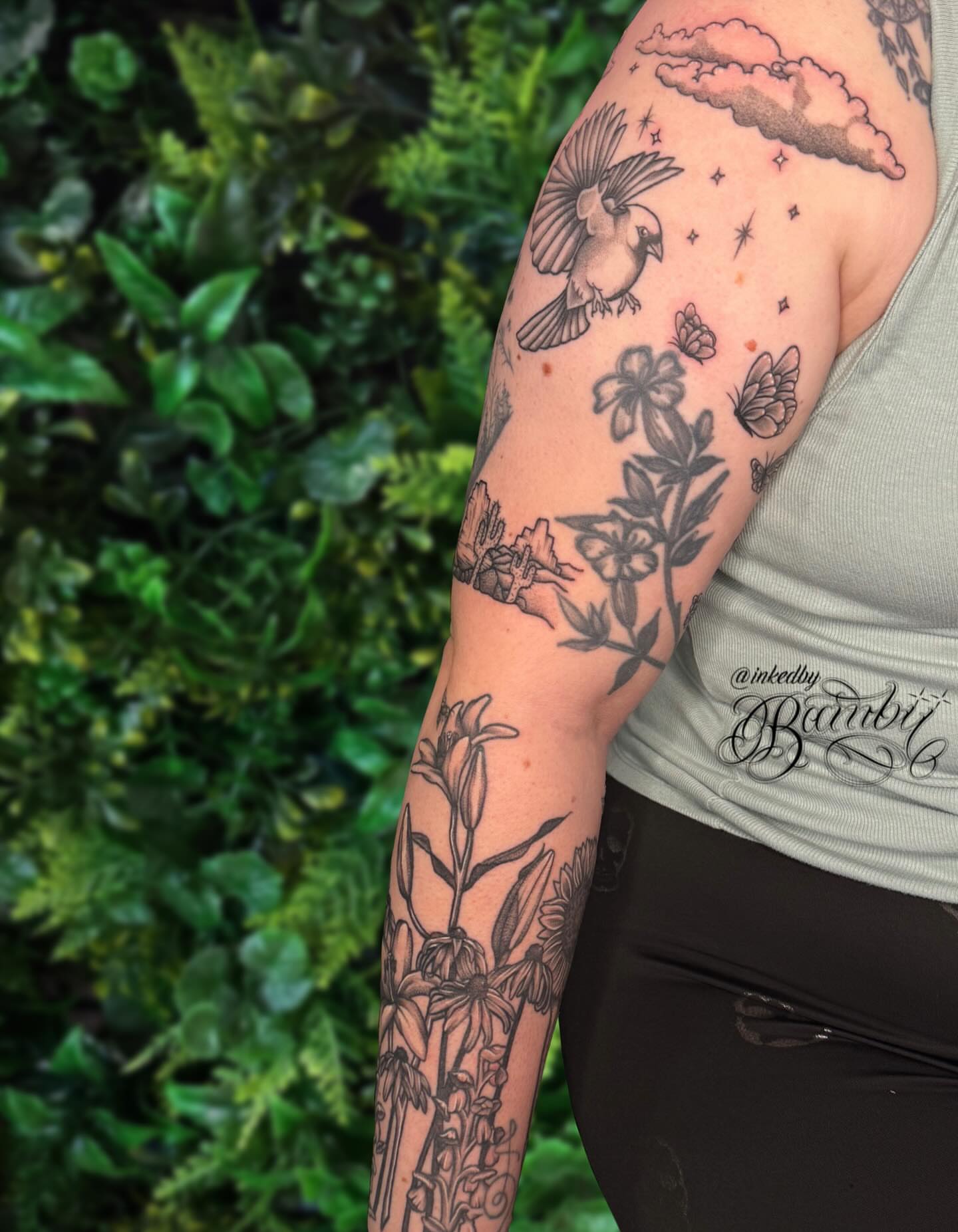 Bird and floral black and grey tattoo on the forearm by Ember