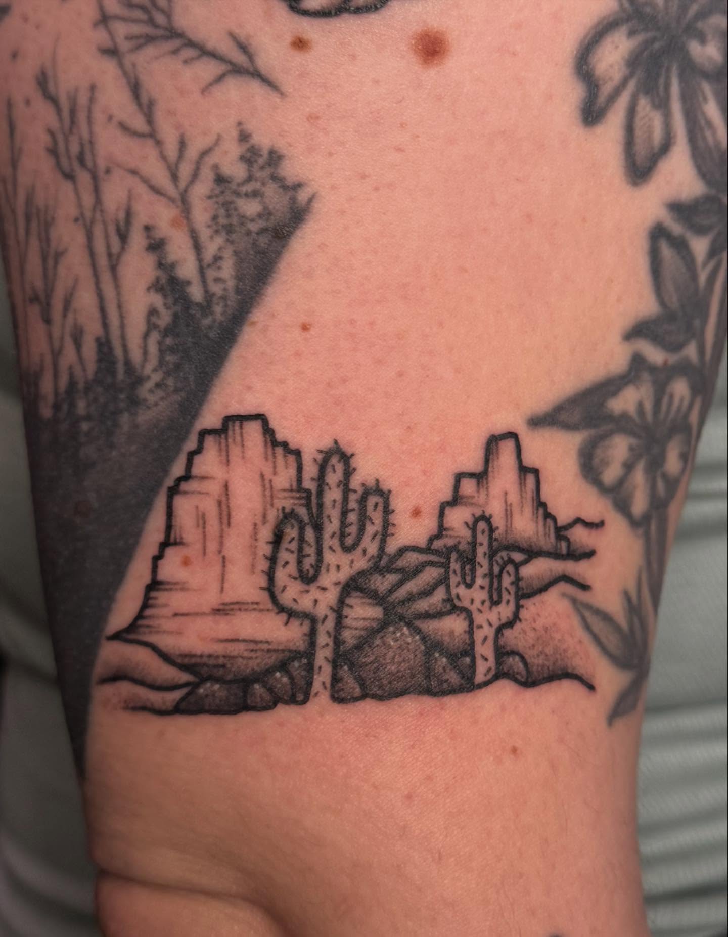 Desert landscape black and grey tattoo on the forearm by Ember