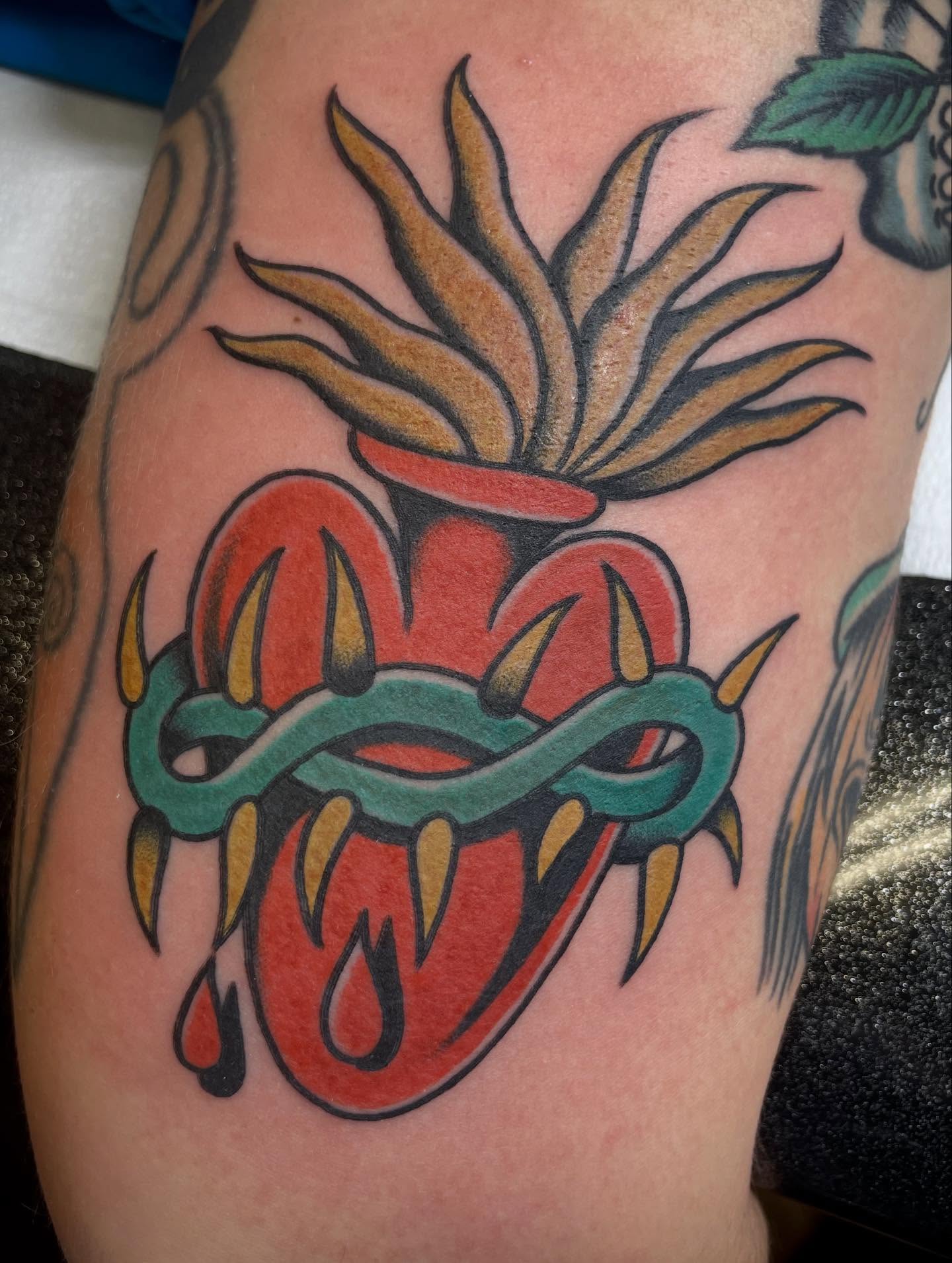 Heart with horns American traditional tattoo on the forearm by Micheal McGlinchey