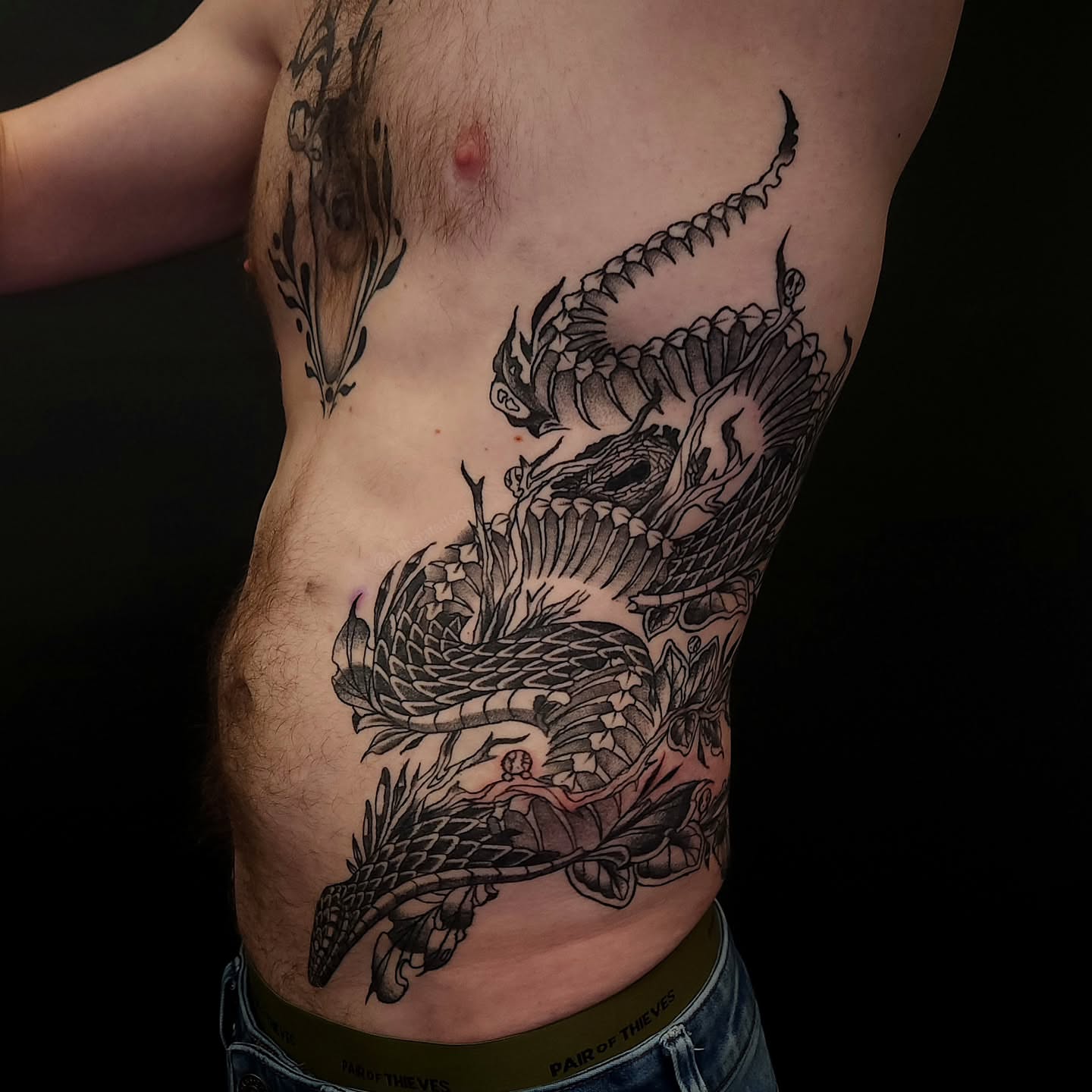 Dragon black and grey tattoo on the ribs by Sheena Yu-Hsin Wood