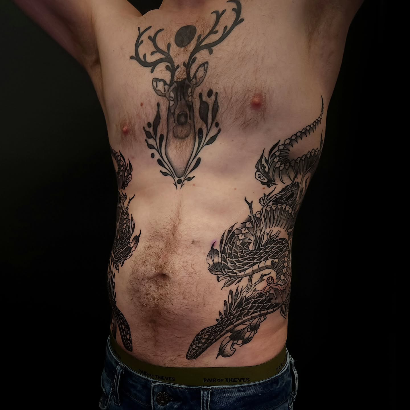 Deer and dragon black and grey tattoo on the torso by Sheena Yu-Hsin Wood