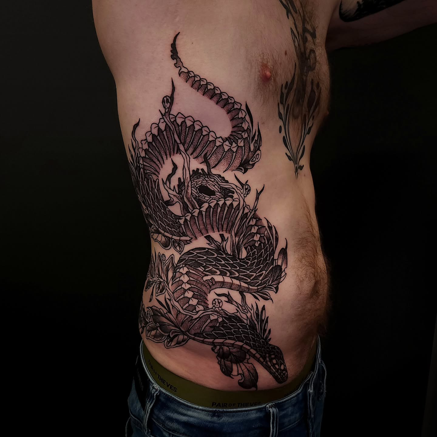 Dragon and flowers black and grey tattoo on the ribs by Sheena Yu-Hsin Wood