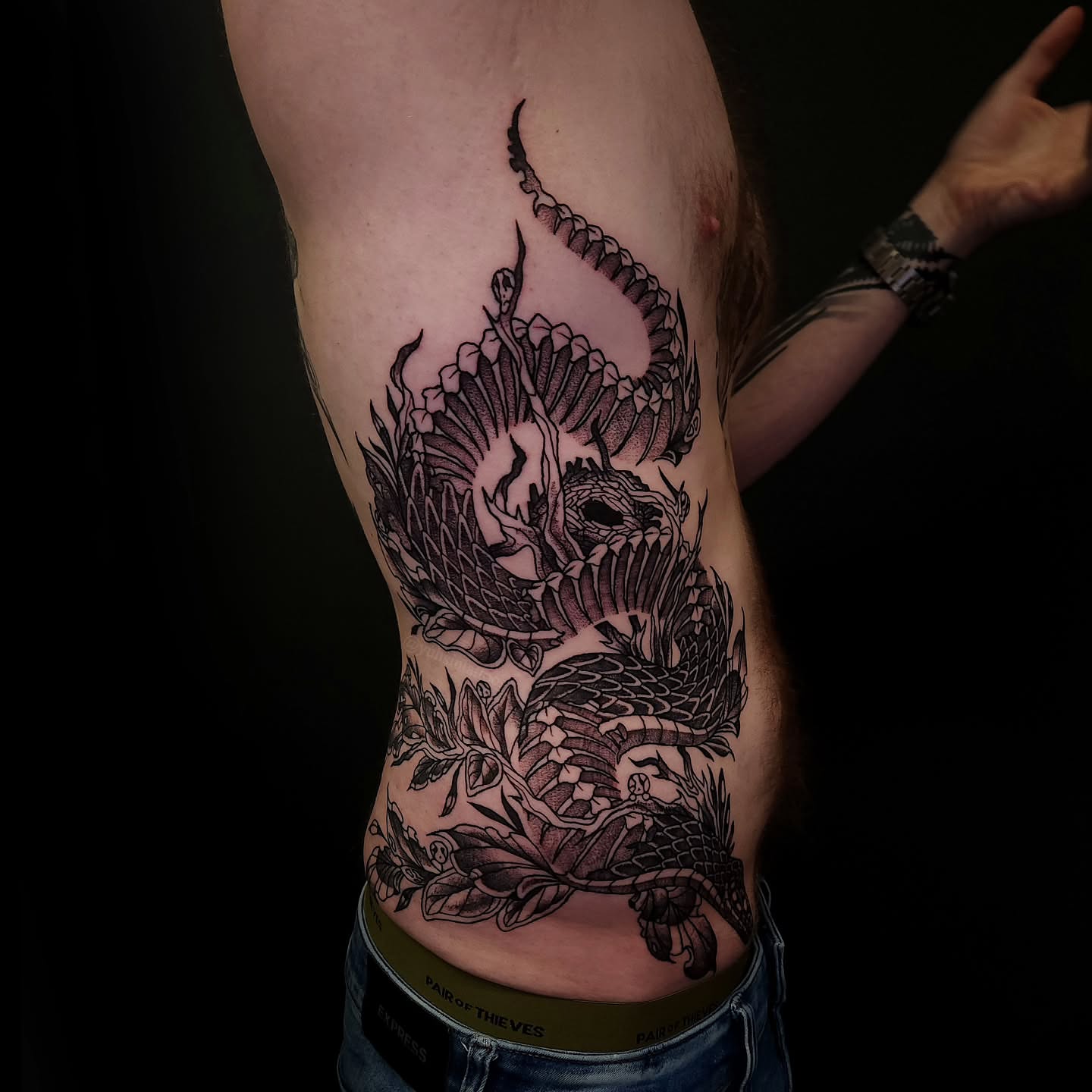 Dragon and floral dotwork tattoo on the ribs by Sheena Yu-Hsin Wood