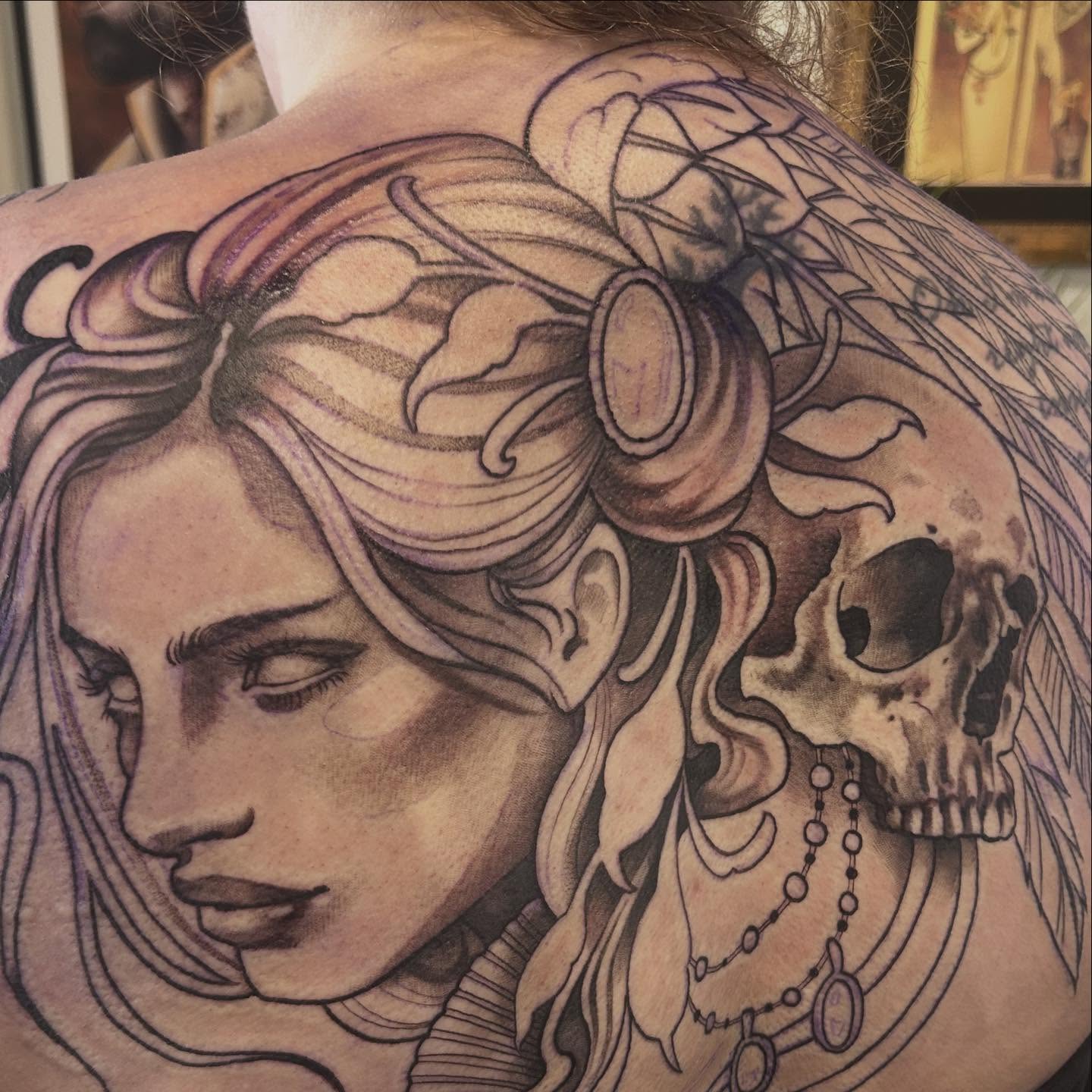 Woman with skull realism tattoo on the back by Whitney Harbin