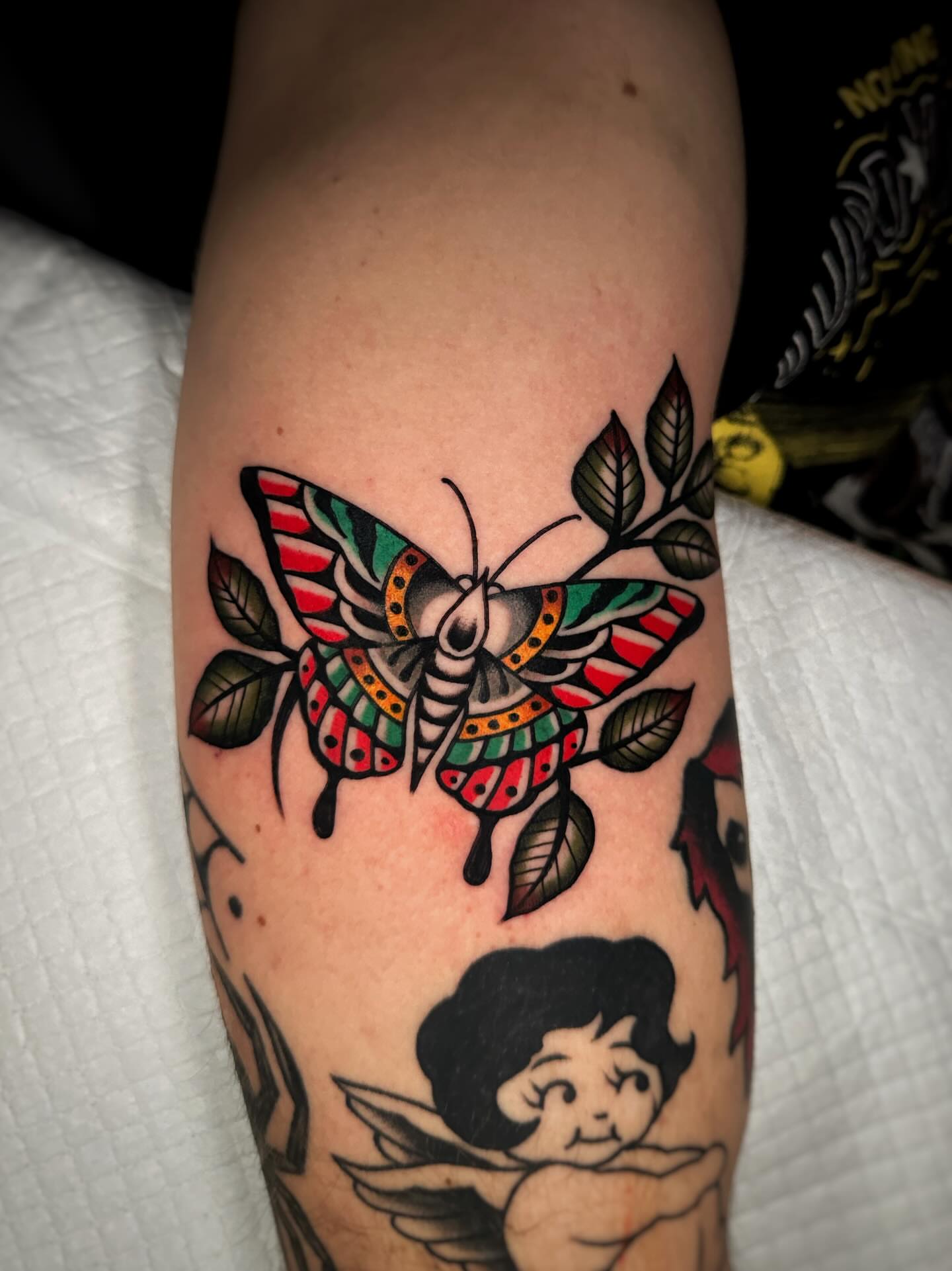 Butterfly American traditional tattoo on the forearm by Alex Finnerty, Reading, Massachusetts