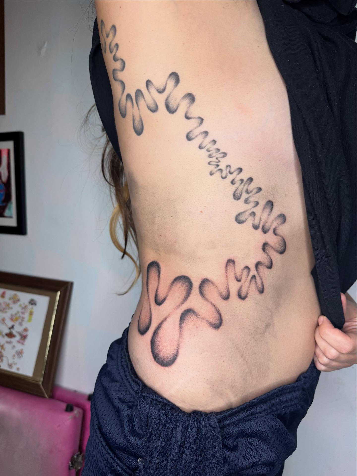 Wave pattern black and grey tattoo on the ribs by @mr.smiley___