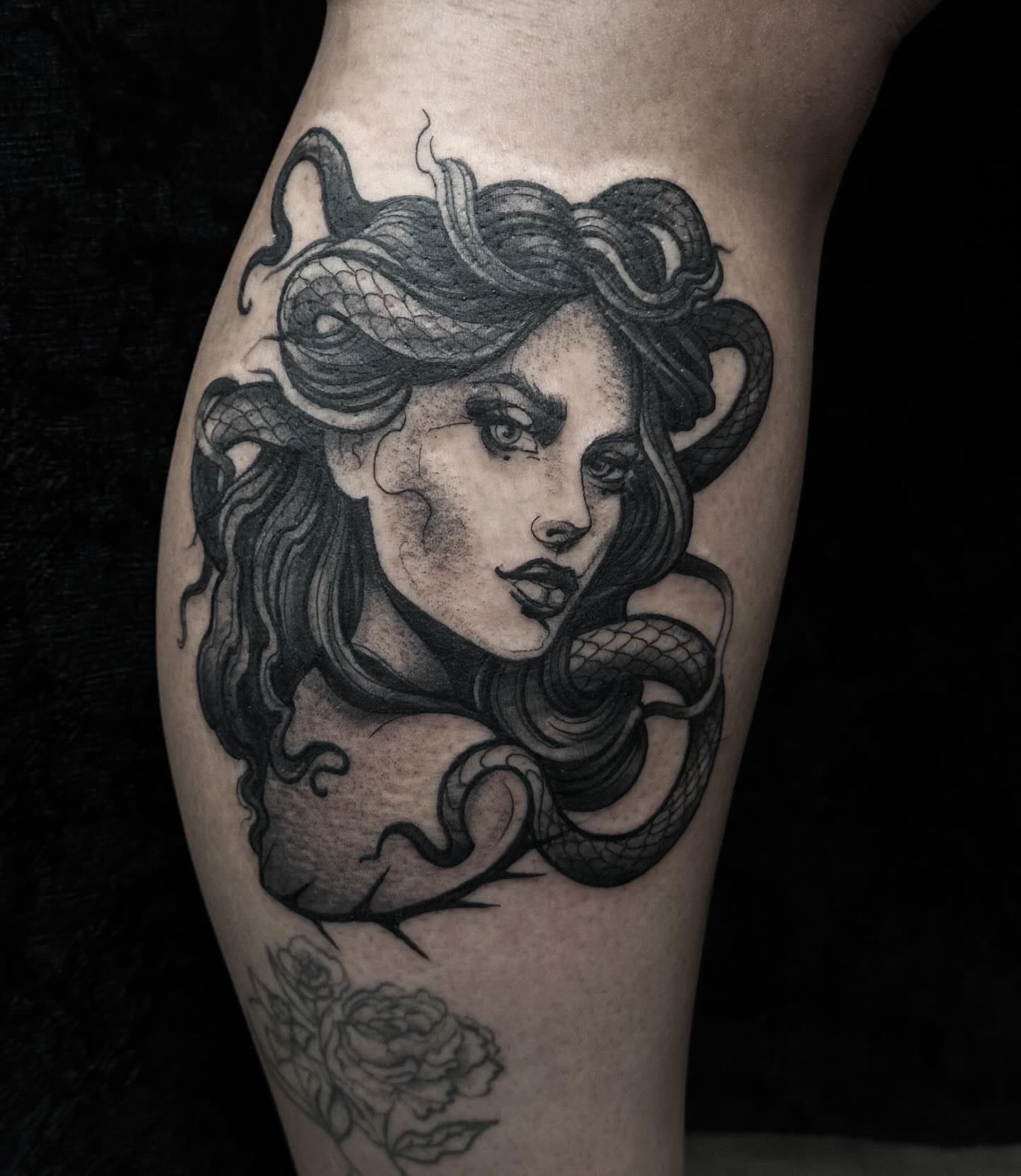 Woman with snakes realism tattoo on the thigh by Elvira Savchuk