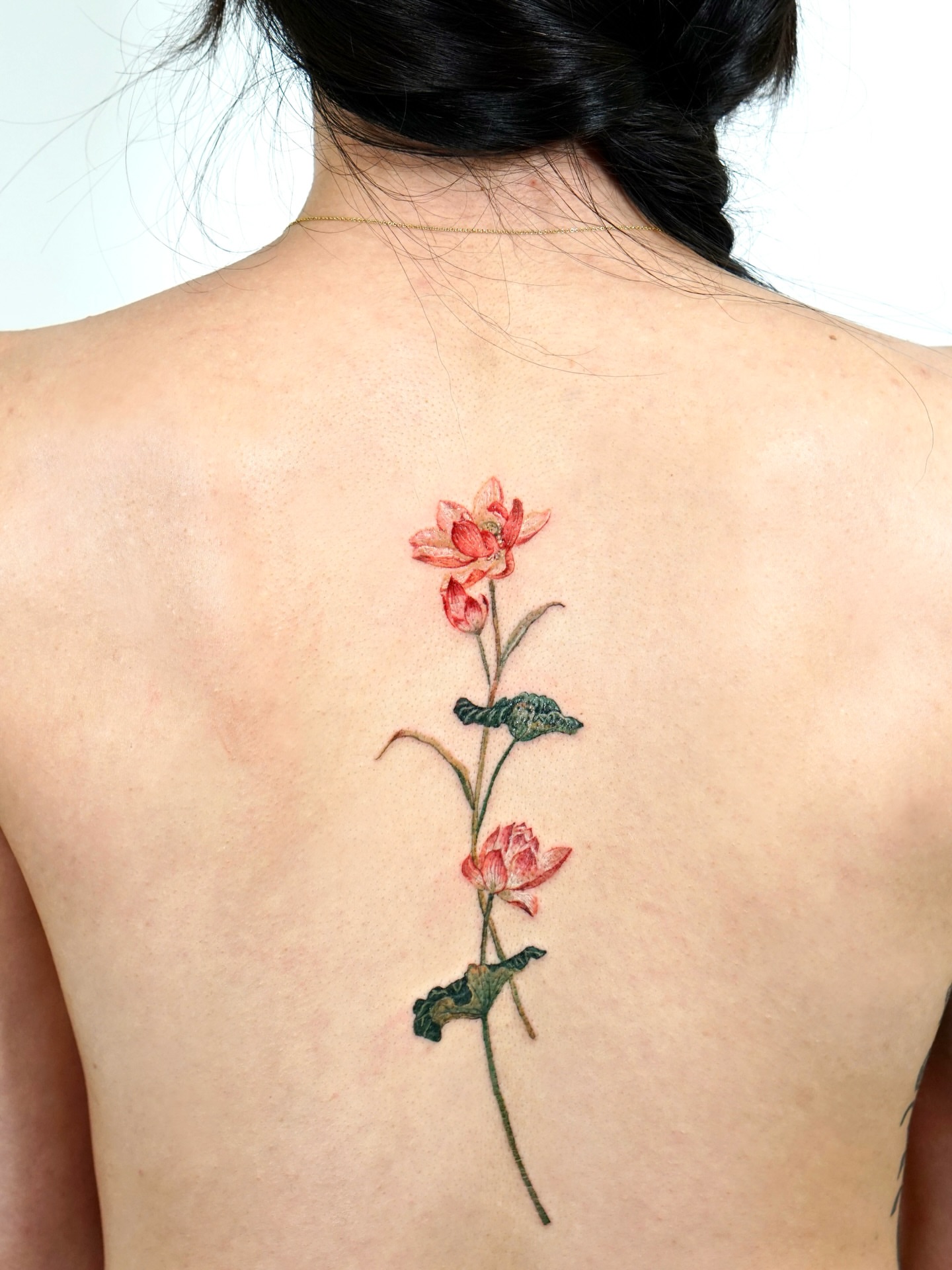 Lotus flower realism tattoo on the back by Isle