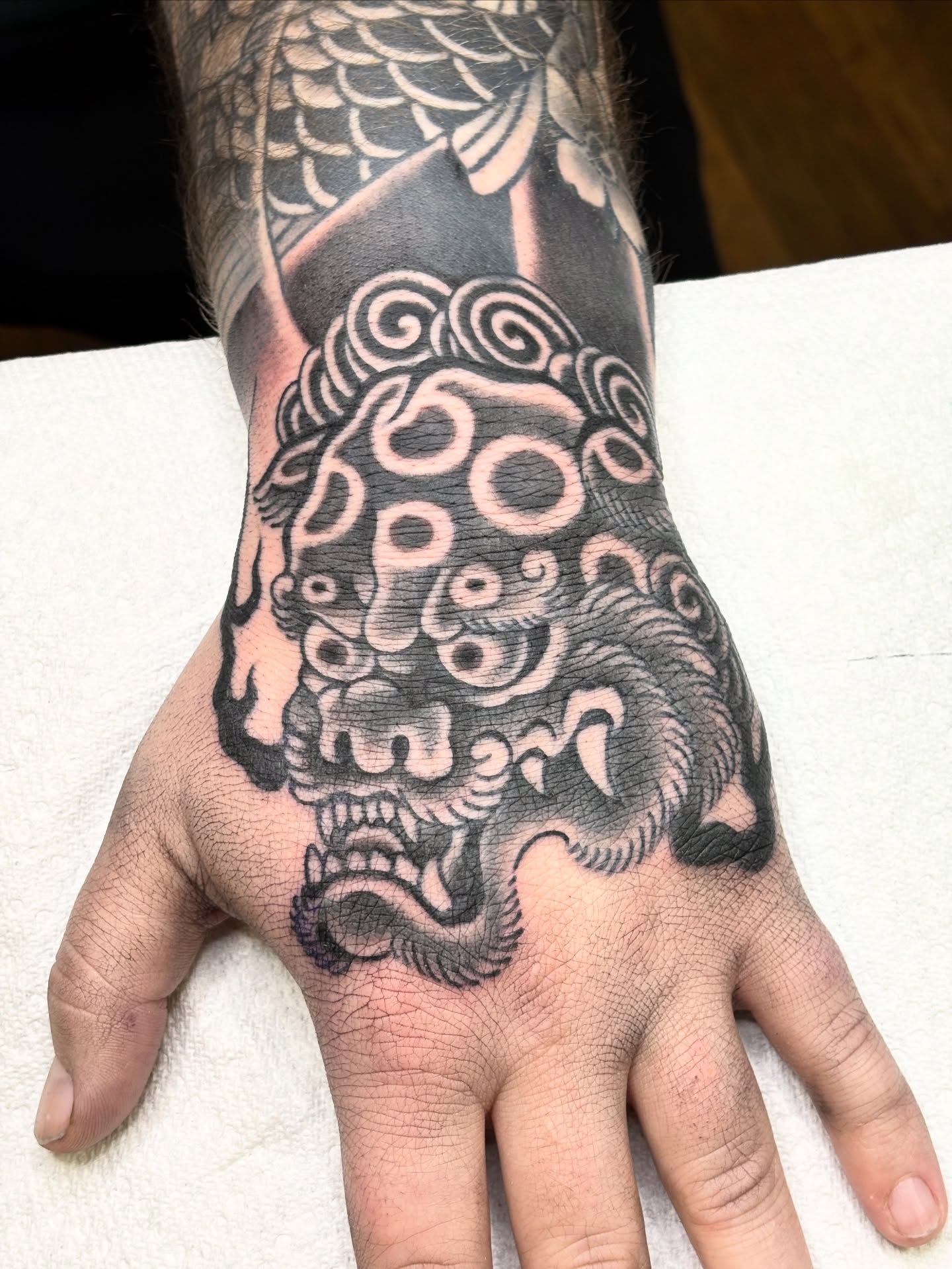 Lion mask japanese irezumi tattoo on the hand by Mike DiCicco