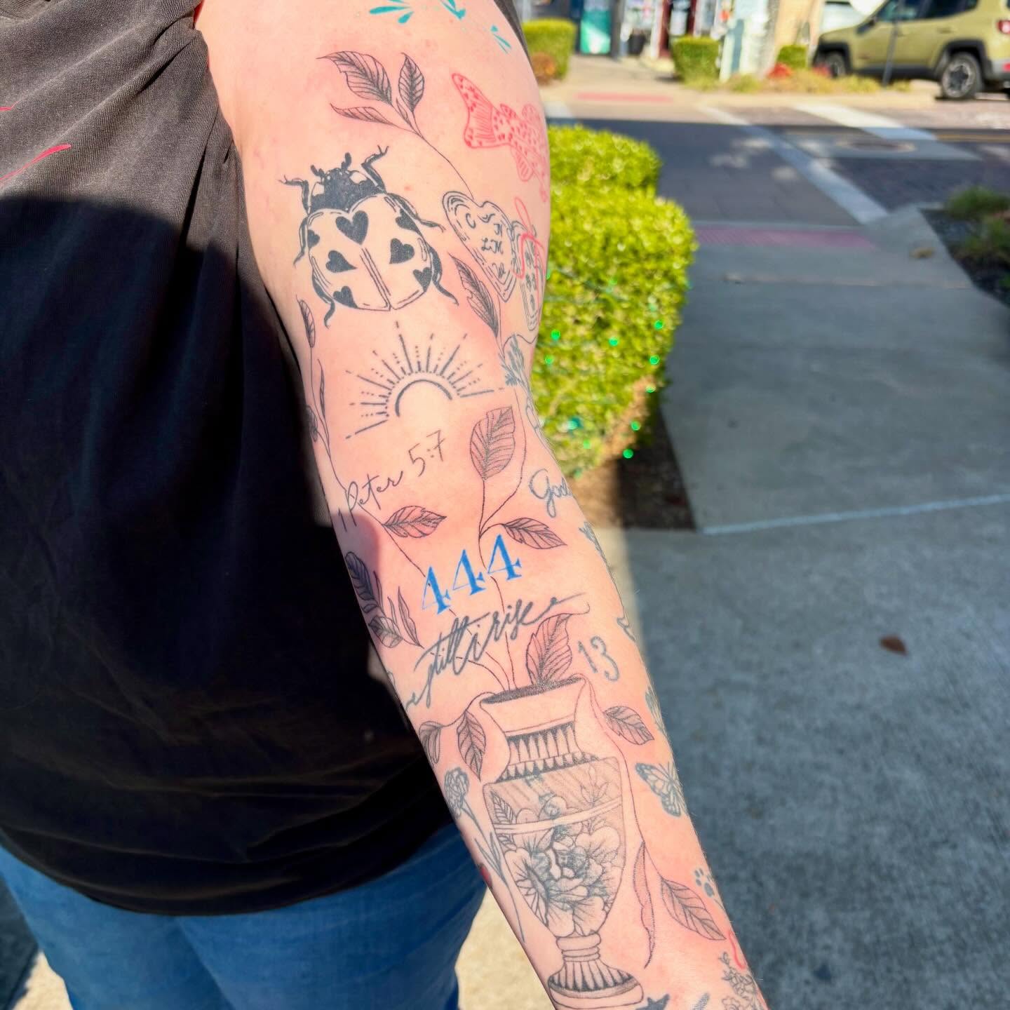 Ladybug and floral motifs American traditional tattoo on the forearm by bradyn thornton: eco-tattoo artist