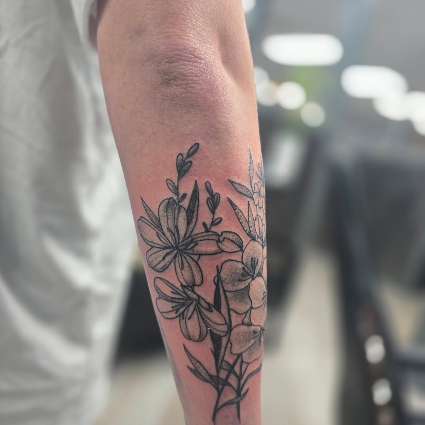 Flowers black and grey tattoo on the forearm by Karen Cain
