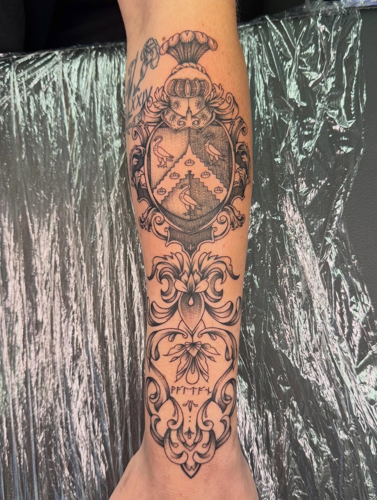 Coat of arms black and grey tattoo on the forearm by haylie