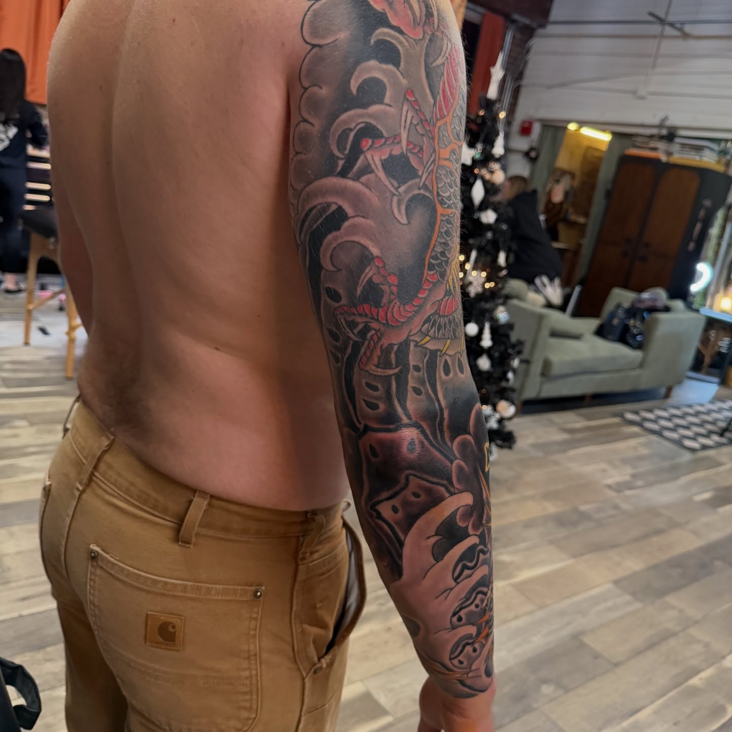 Dragon and waves japanese irezumi tattoo on the upper arm by Trevor Berry
