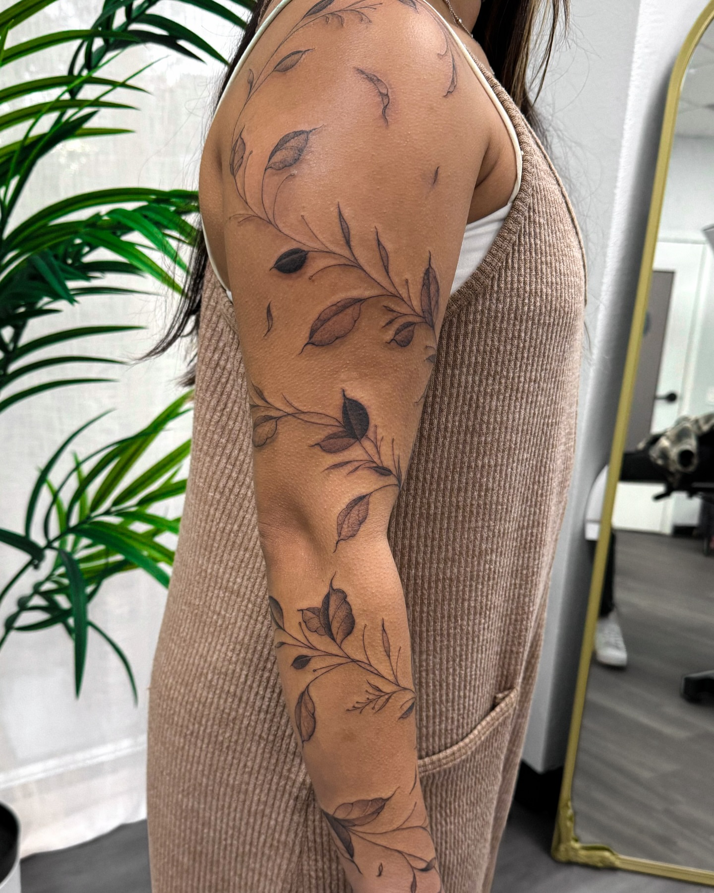 Leafy branches black and grey tattoo on the upper arm by Daniel Montoya, Charlotte, North Carolina