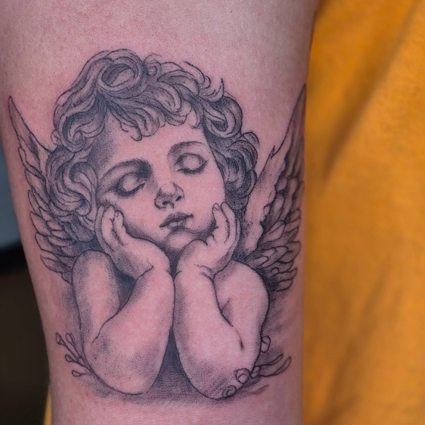 Cherub dotwork tattoo on the forearm by Chris Bell