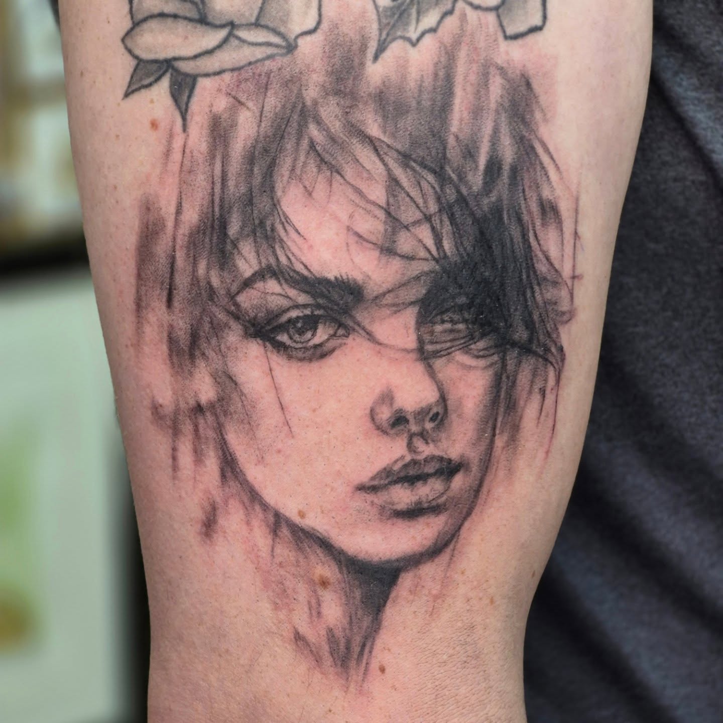 Portrait realism tattoo on the forearm by Chris Bell