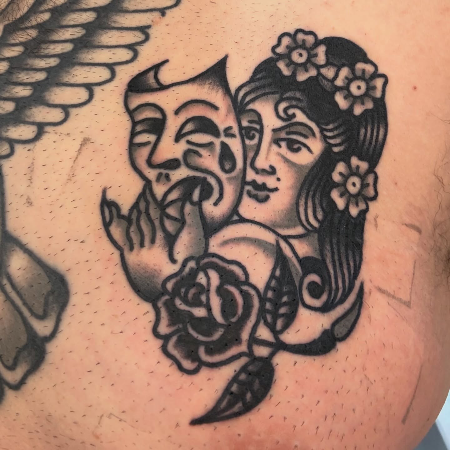 Theater masks and woman American traditional tattoo on the shoulder by Stevie Lowenstein, Cincinnati, Ohio