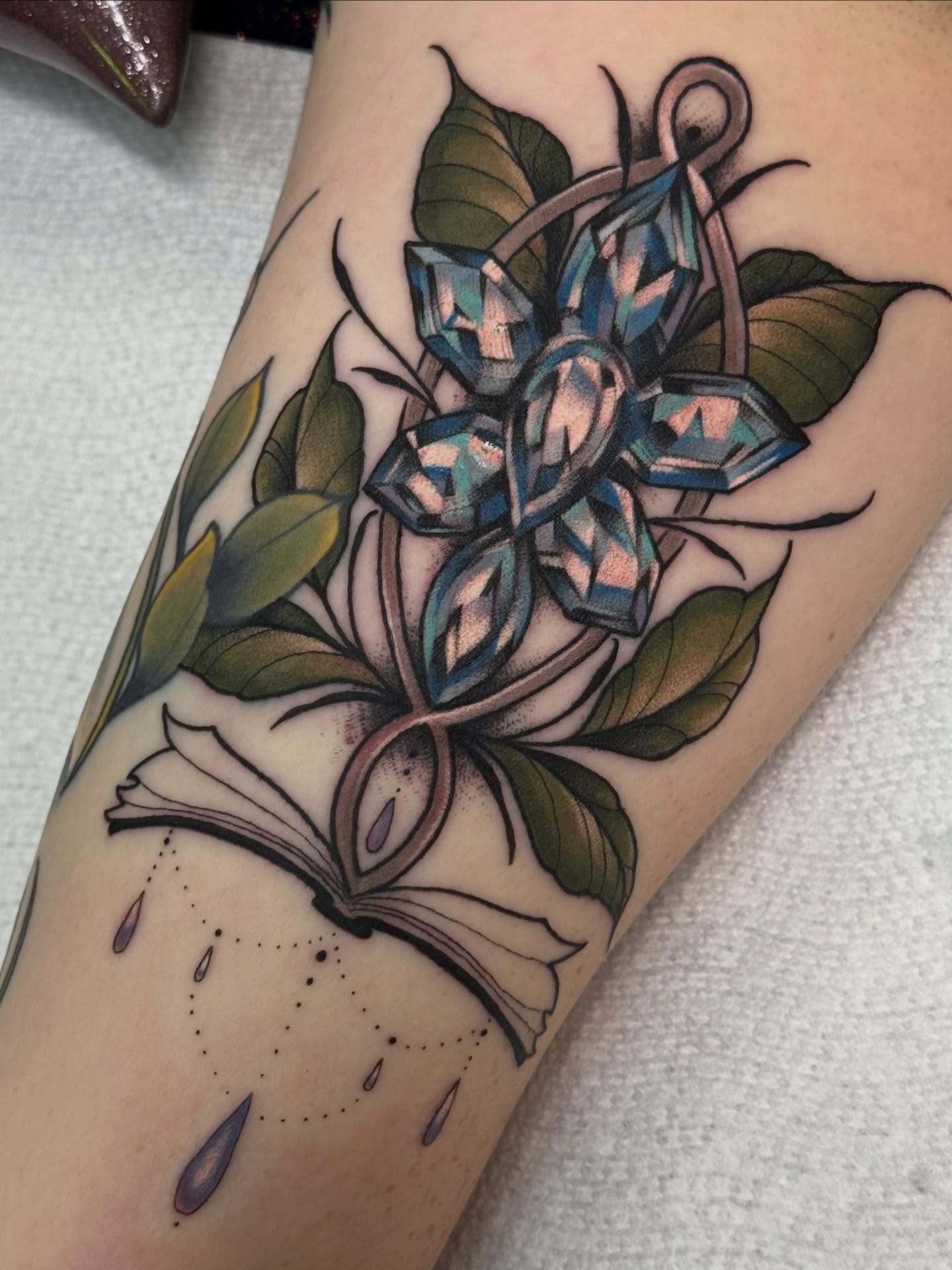 Book with gemstones dotwork tattoo on the forearm by Espinal