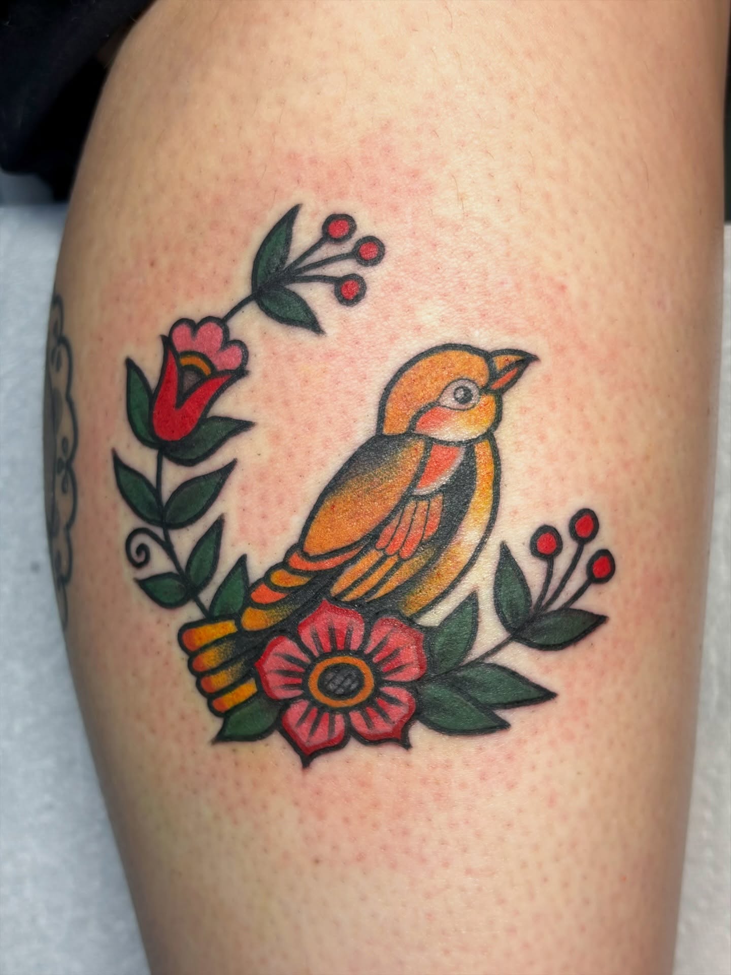 Bird and flowers American traditional tattoo on the thigh by edith🌷, Murfreesboro, Tennessee