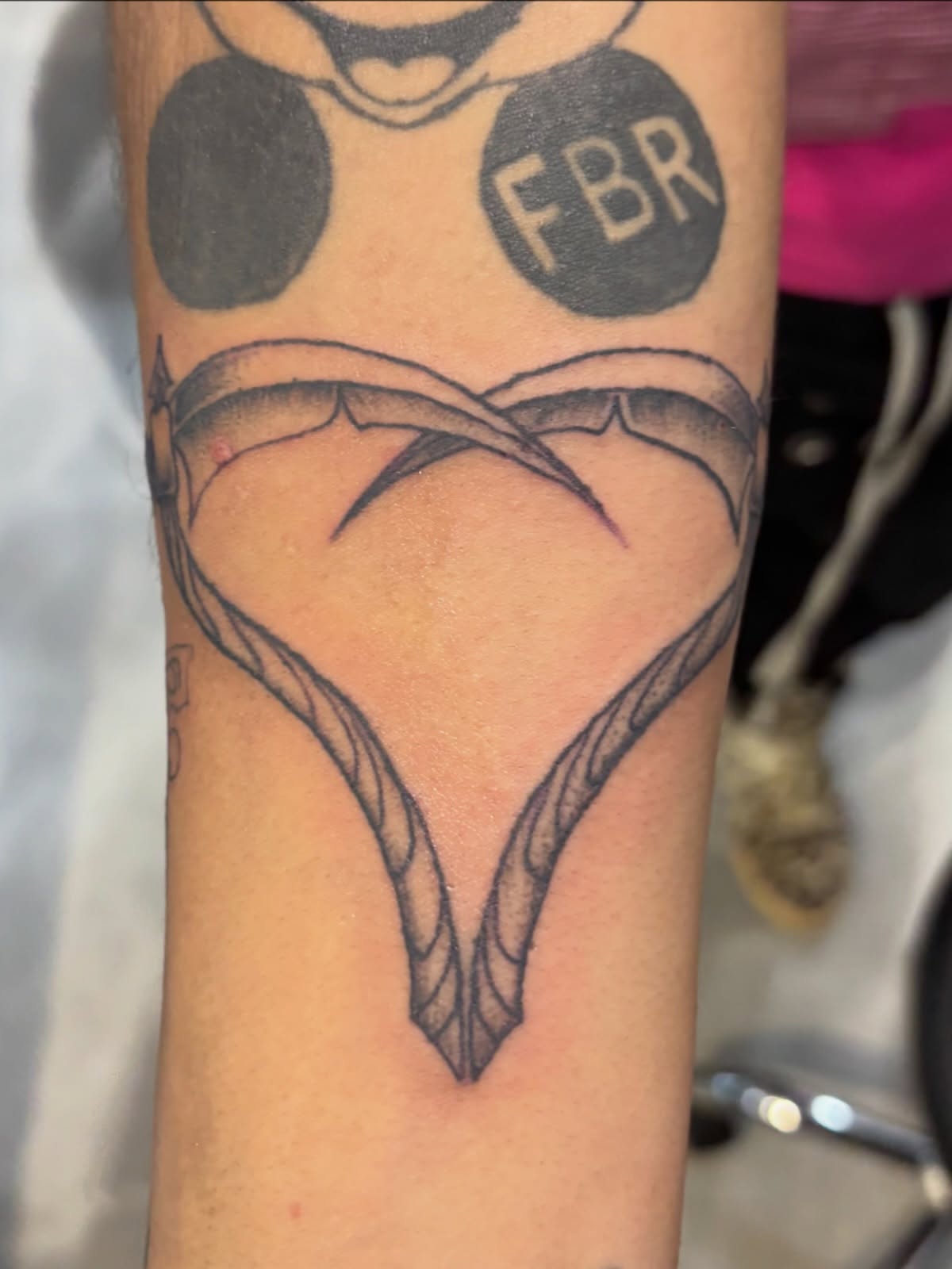Heart with rope black and grey tattoo on the forearm by Miklo Montoya